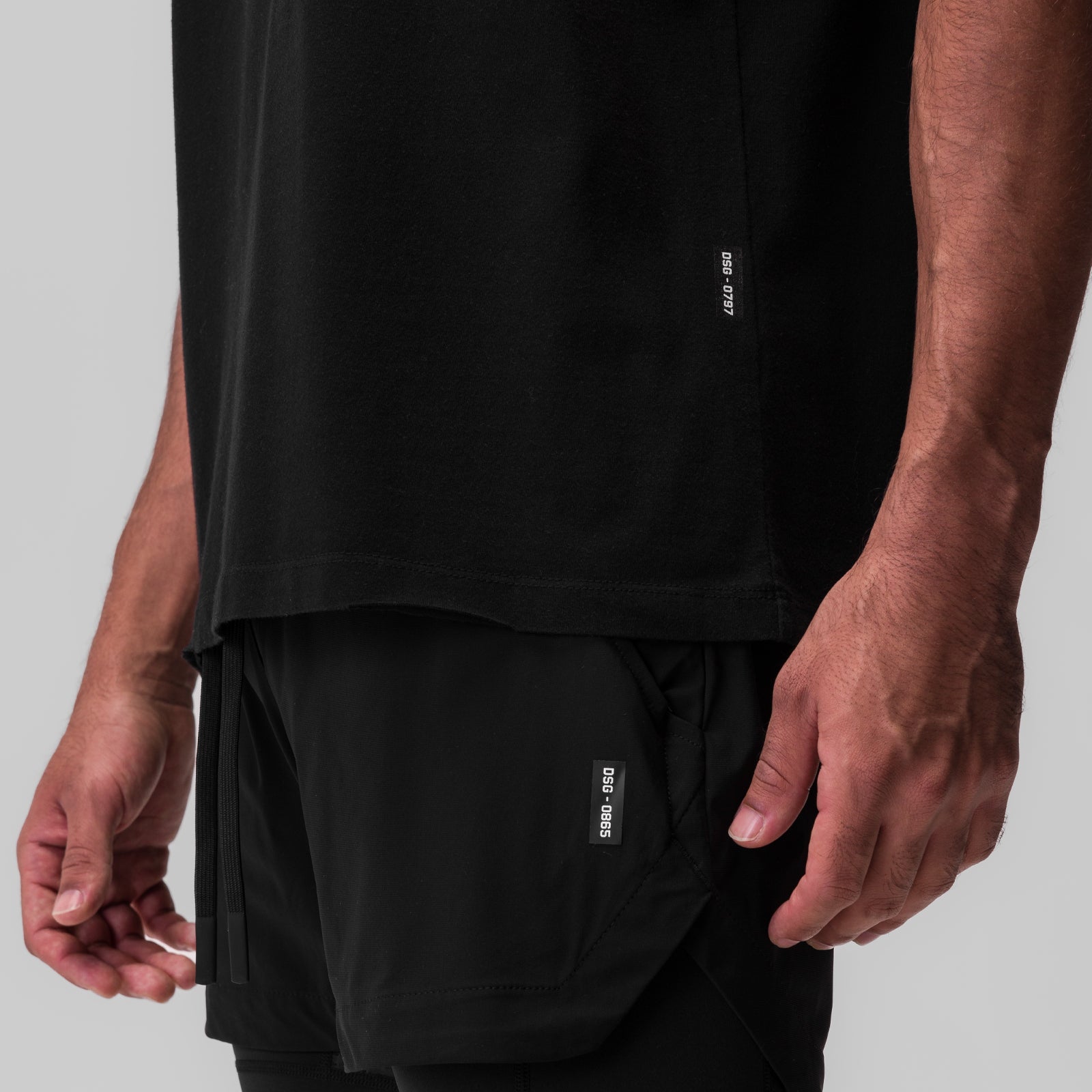 Black Tech Essential Relaxed Tee worn by model, side detail view showing fit and fabric