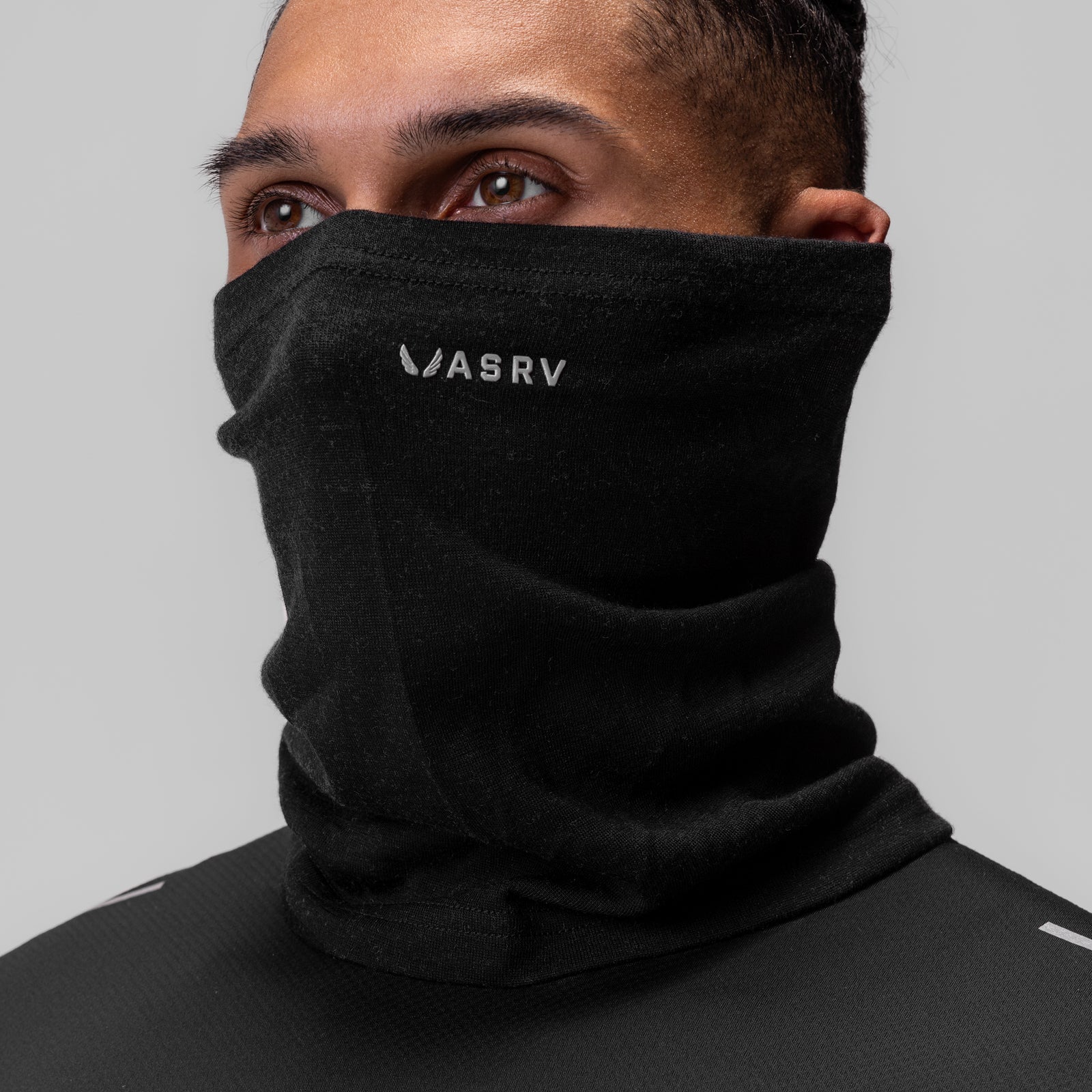 Black Merino Wool Gaiter worn as neck gaiter, front view on model