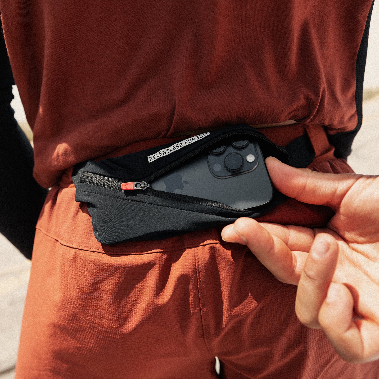 Ripstop Belt Pack in brick and black, worn on model's waist