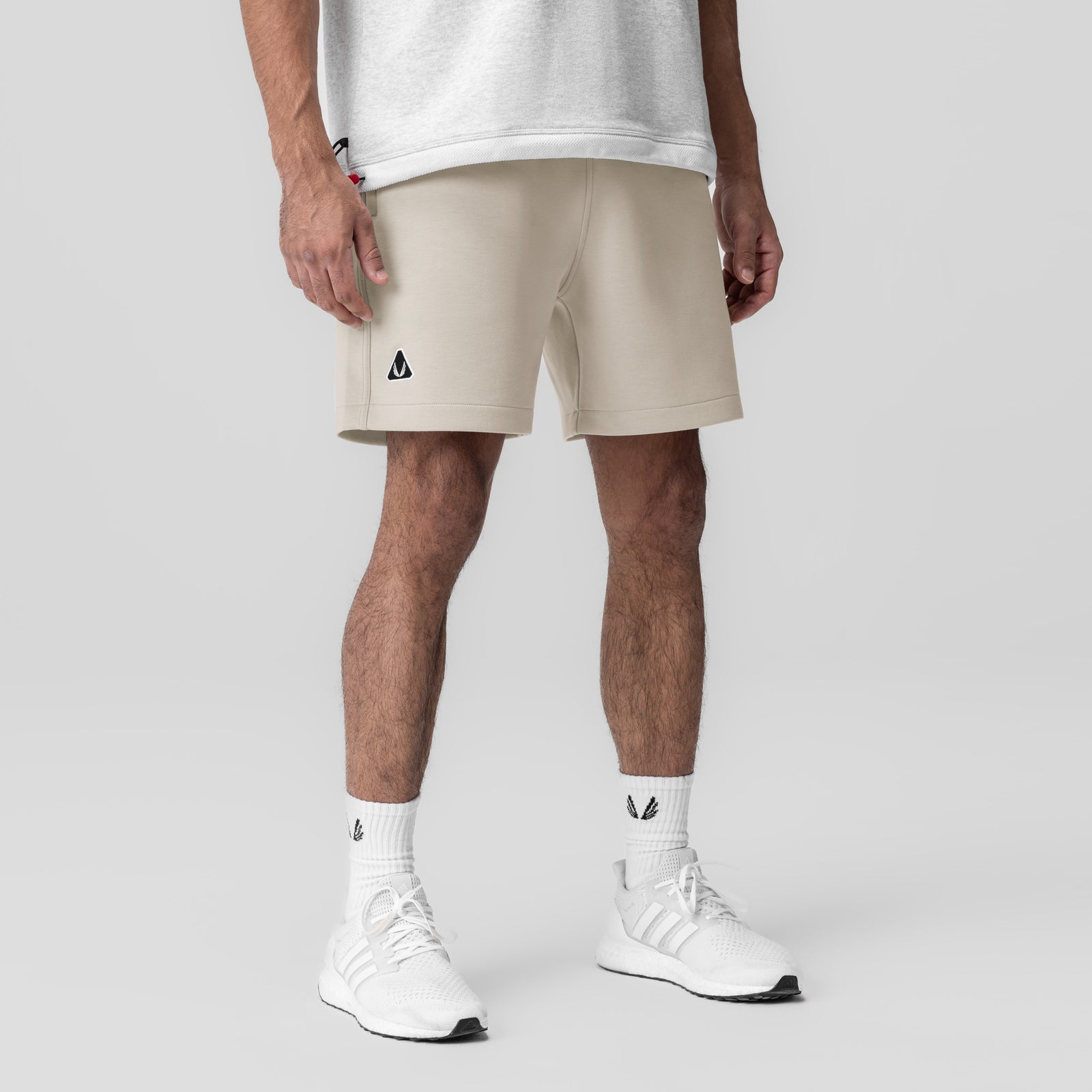 Dri-Core Training Short in Chai worn by model with white sneakers and socks, front view