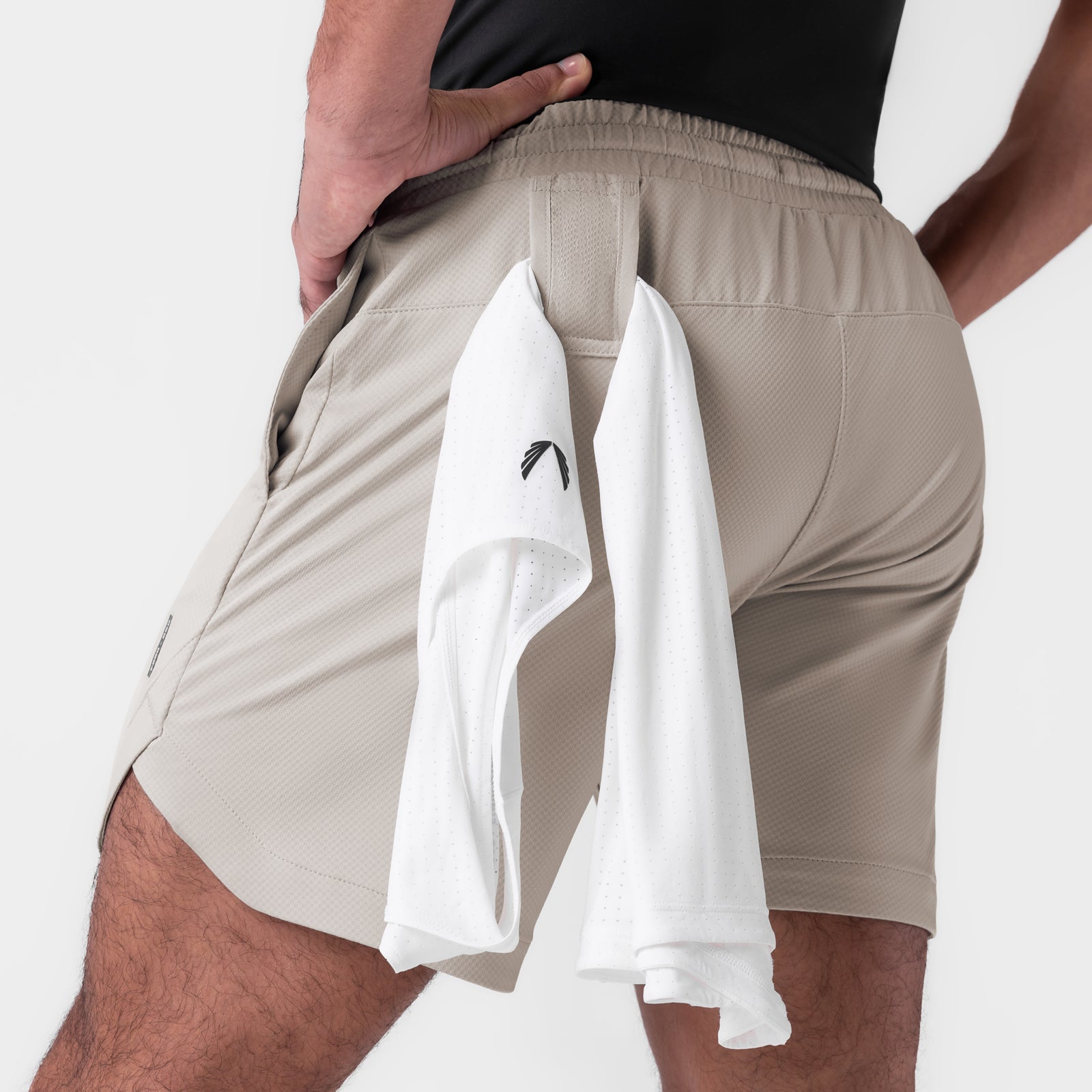 AeroSilver 7" Linerless Short in Chai, worn by model showing back view with towel