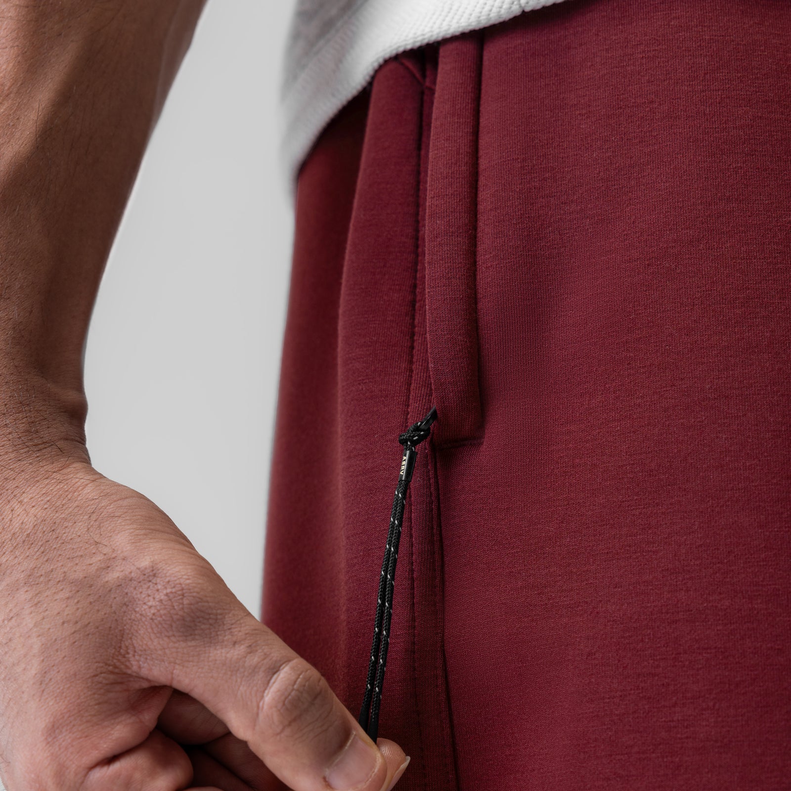 Dri-Core Training Short in Crimson being worn, side seam detail closeup