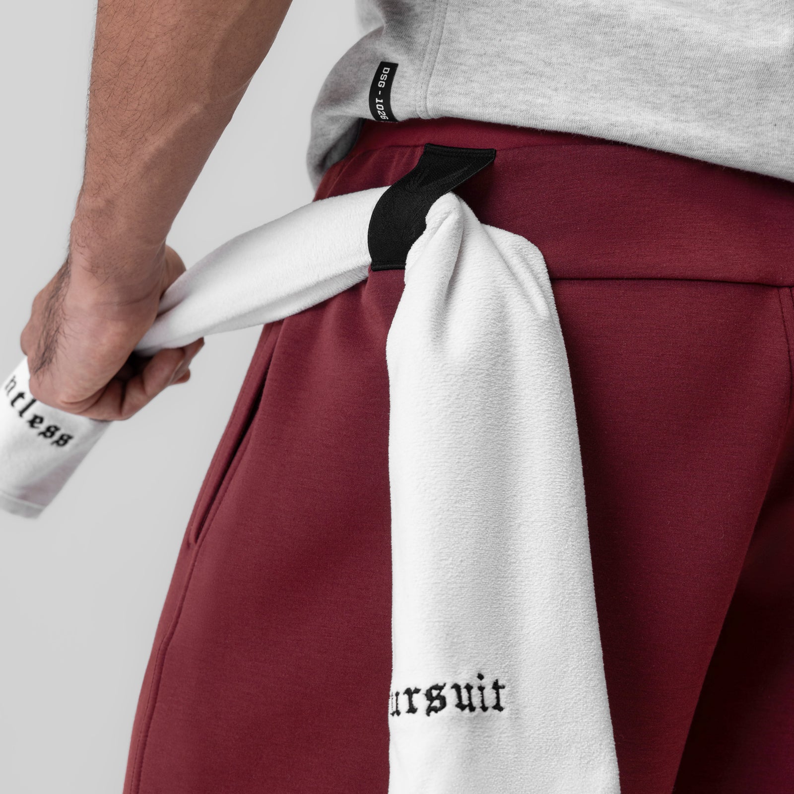 Dri-Core™ Training Short in crimson, worn by model holding white towel with brand text