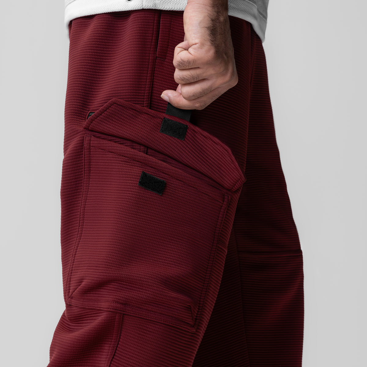 Deltapeak Cargo Cinch Jogger in crimson, model wearing side view showing cargo pockets