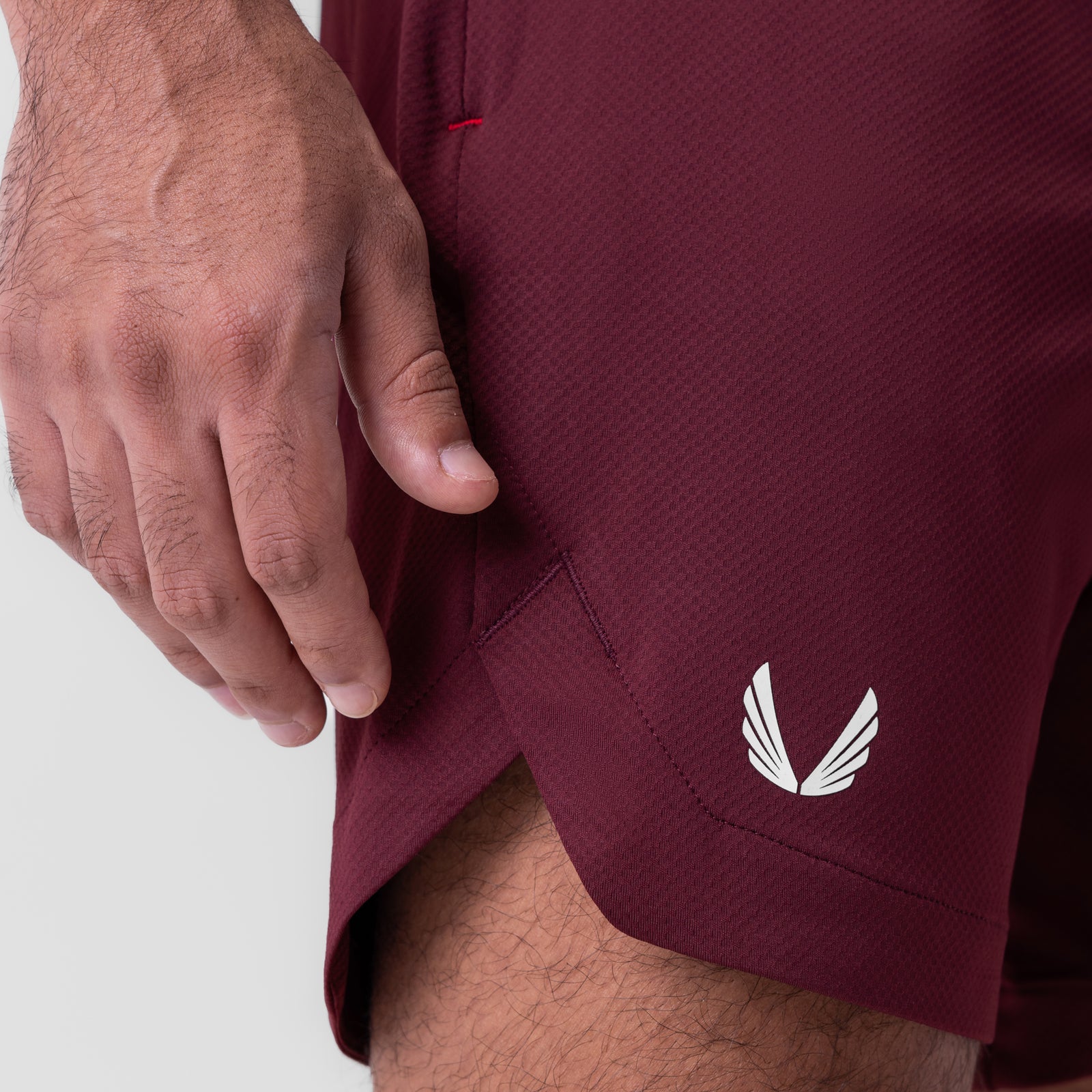 AeroSilver 7" Linerless Short in crimson, worn by model showing side pocket detail