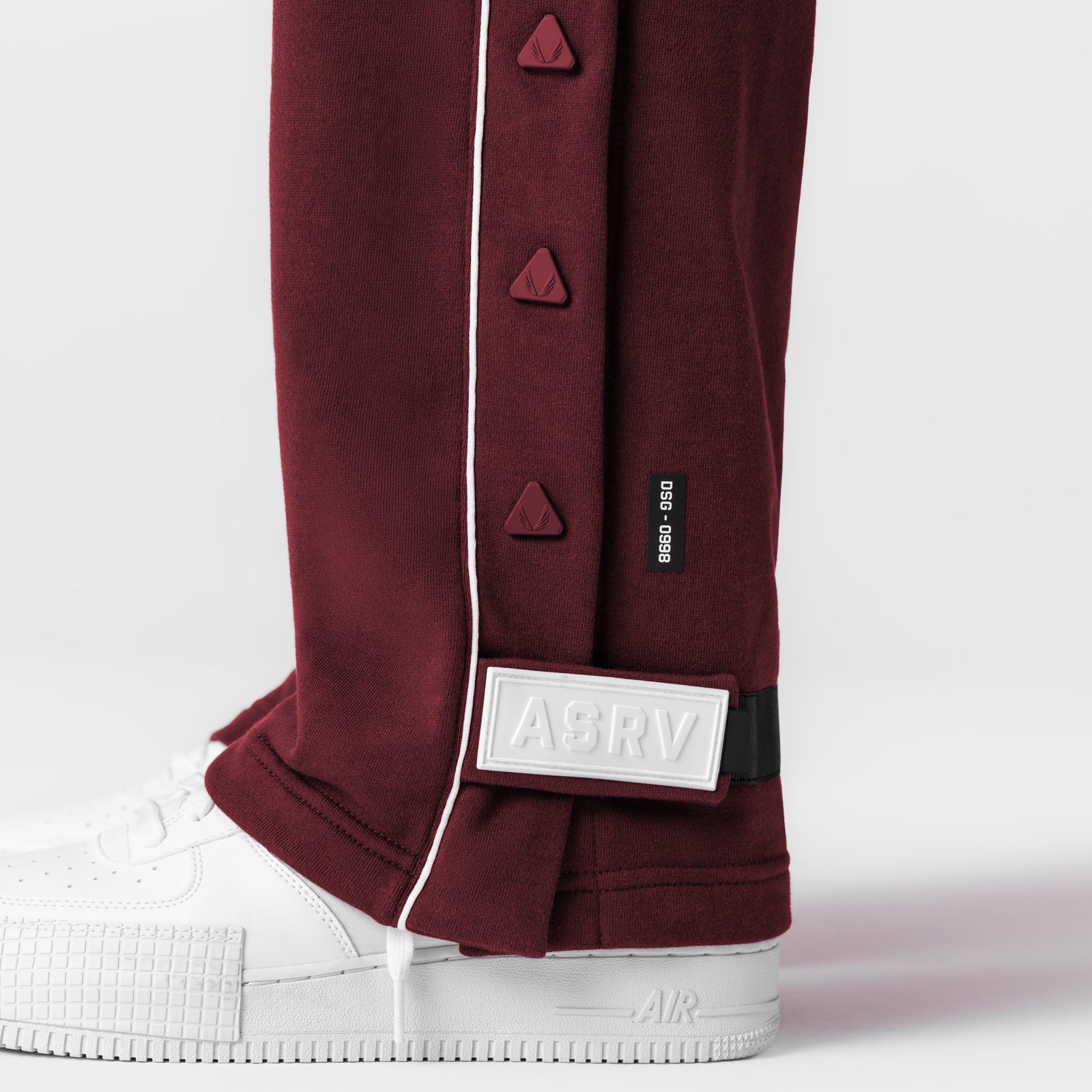 Herringbone Terry Snap Button Sweats in Crimson worn with white sneakers, detail view