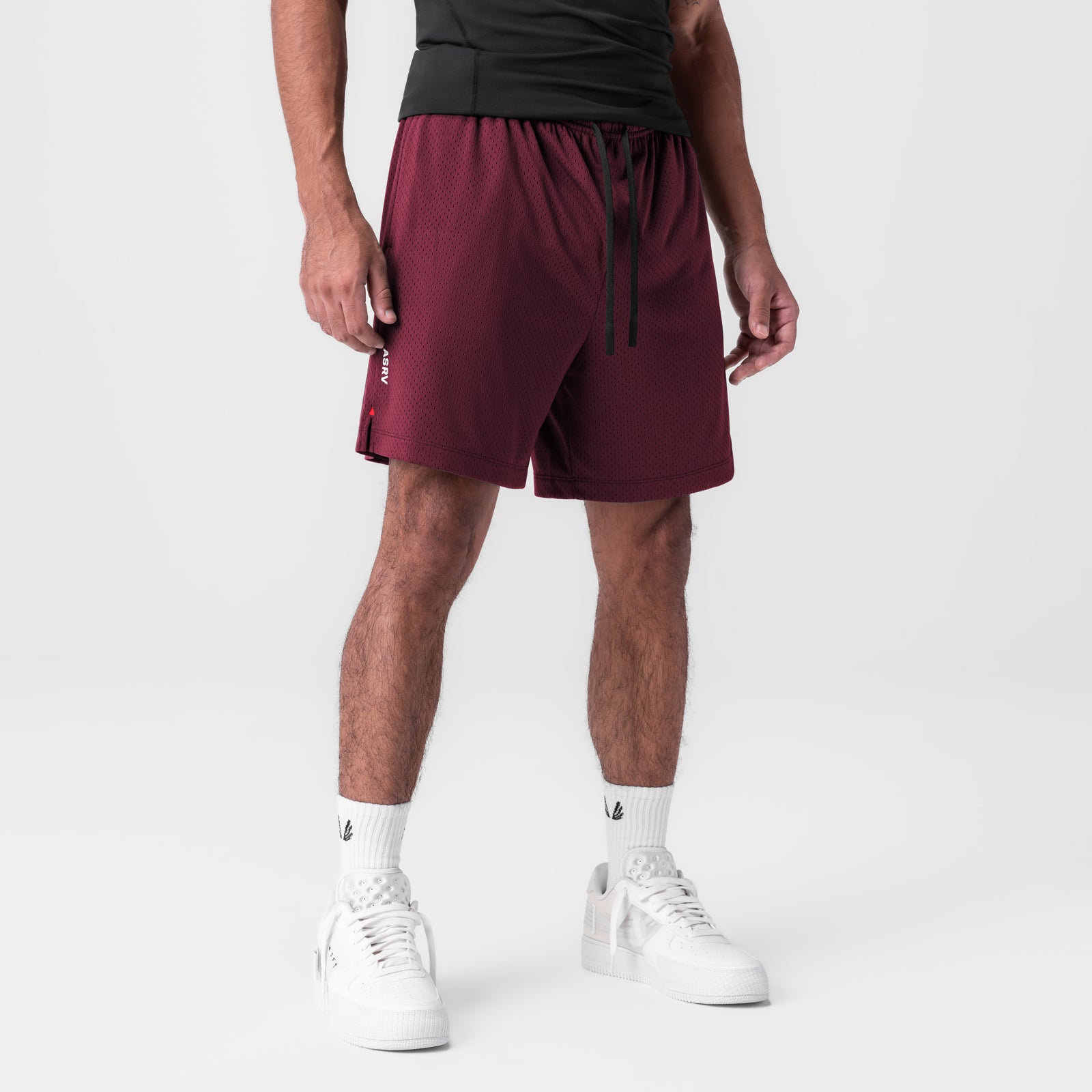 Reversible 2-in-1 Short in crimson worn by model with white sneakers, front view