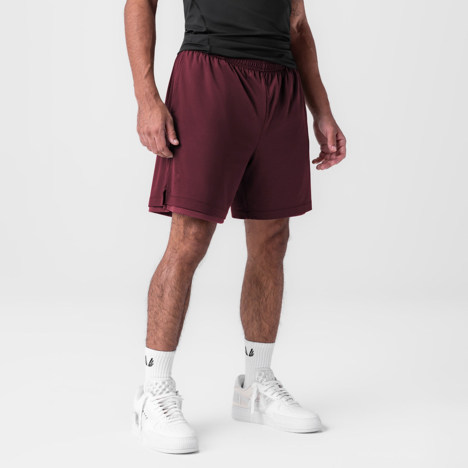 Reversible 2-in-1 Short in crimson worn with black tee and white sneakers, front view