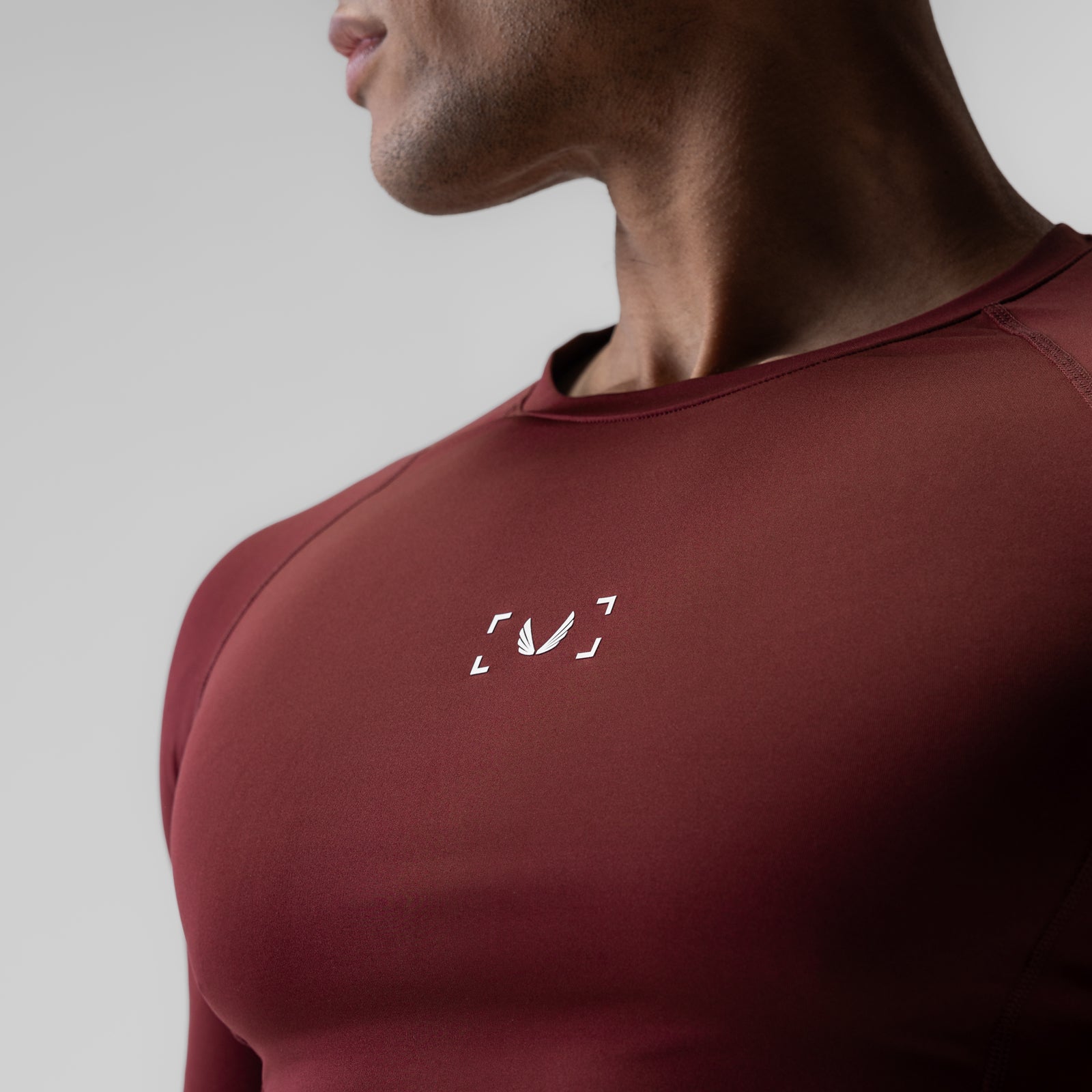 WarpFlexx-Lite half-sleeve baselayer in crimson, worn by model in profile view