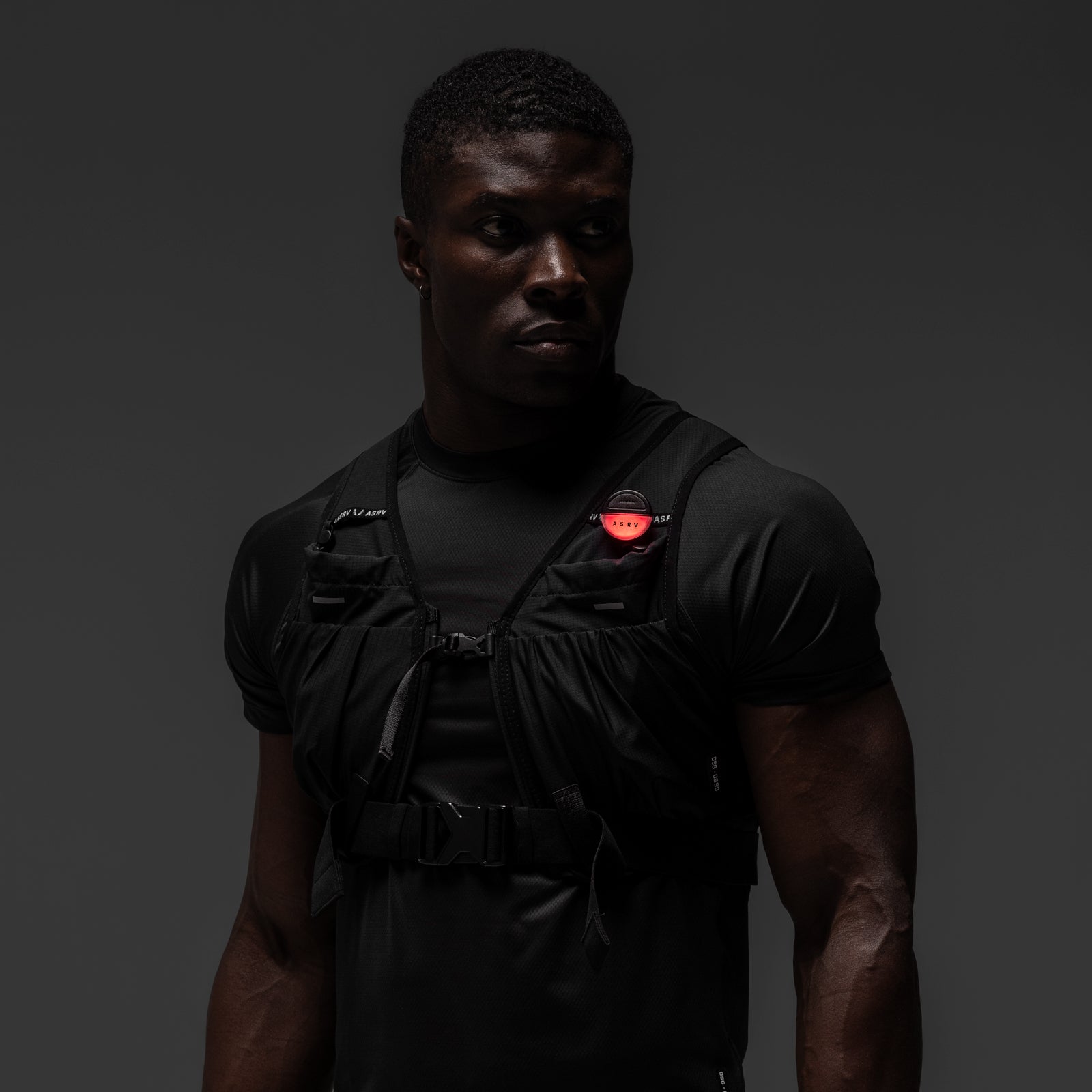 Black tactical vest worn by model, front view, ASRV x Bookman Eclipse