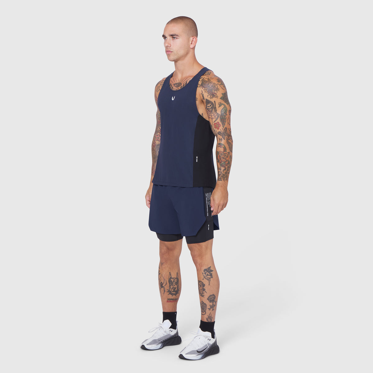 Laser-Vent Singlet Tank in navy/black, worn by male model, side view