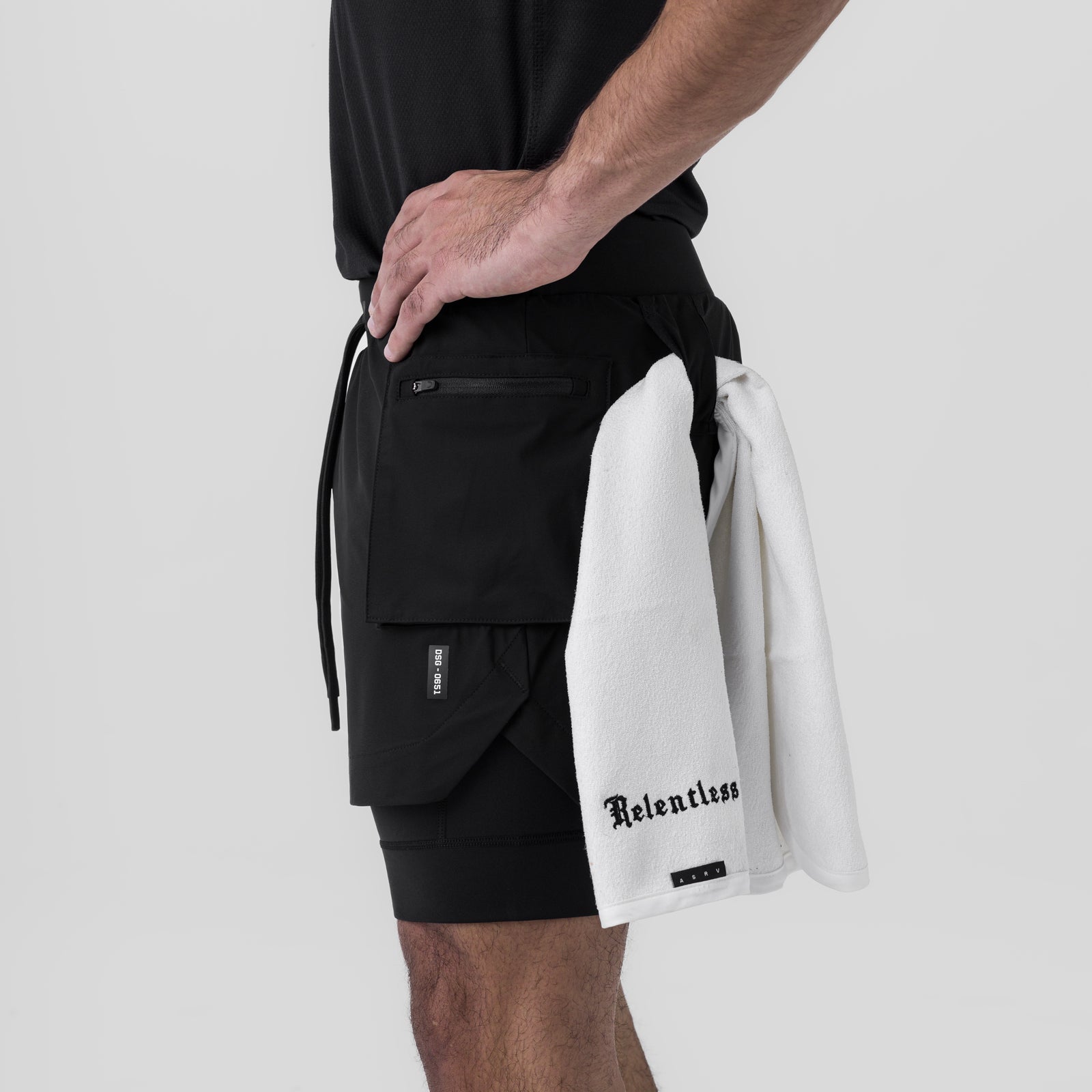 Tetra-Lite Cargo Short in black worn by model, holding white Relentless towel