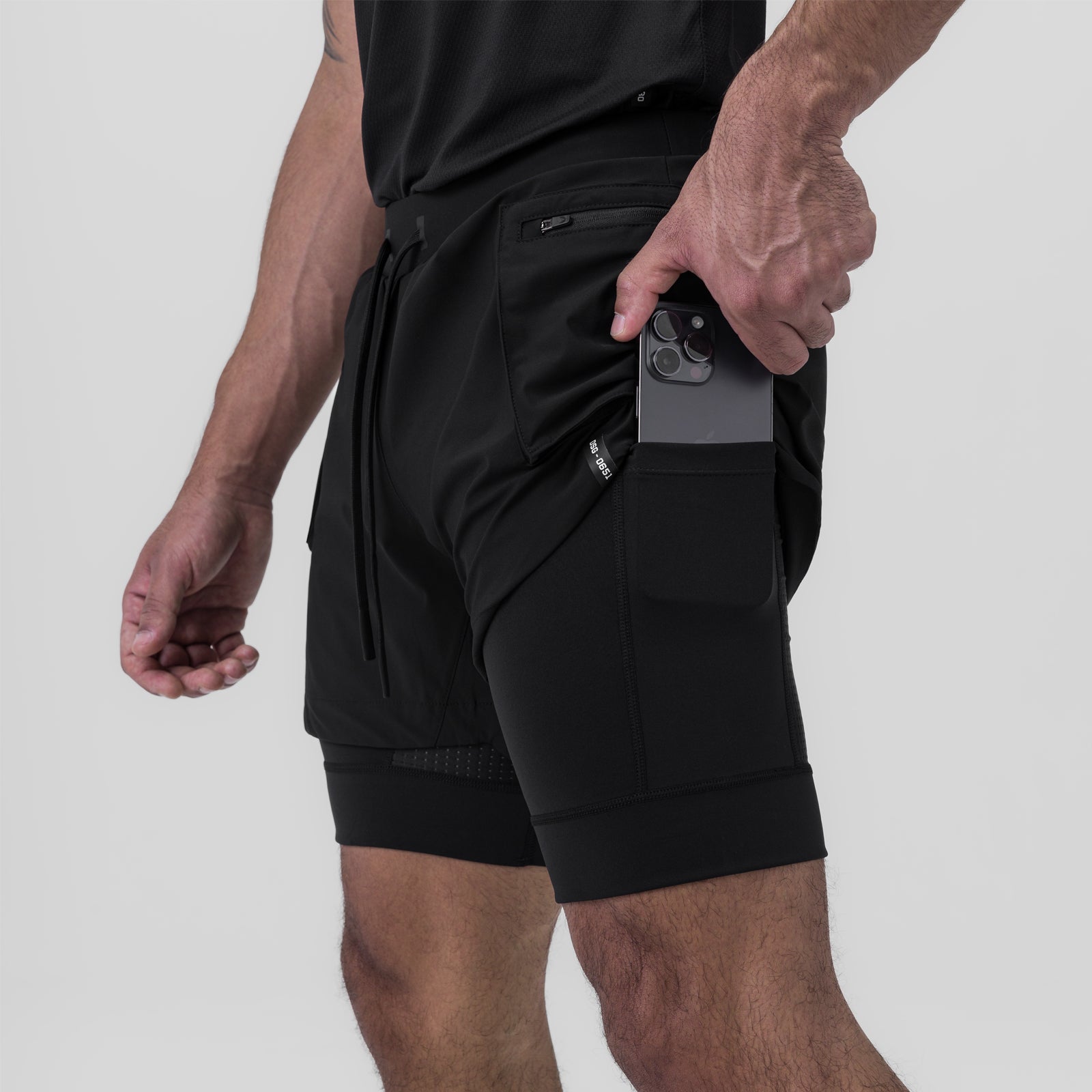 Tetra-Lite Liner Cargo Short in black, worn by model holding phone in pocket