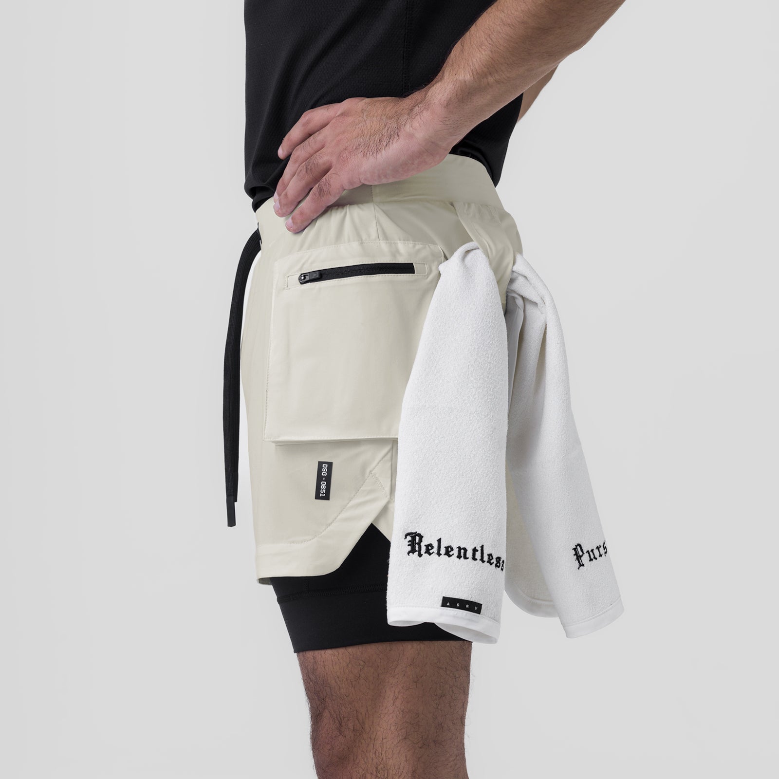 Tetra-Lite Cargo Short in stone worn by model, side view with white towel