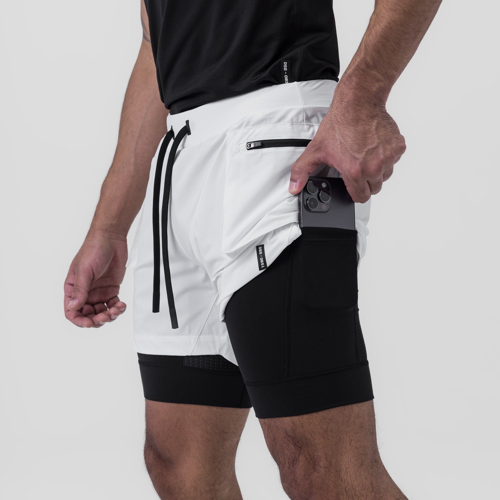 Tetra-Lite Cargo Short in white and black, worn by model showing phone pocket detail