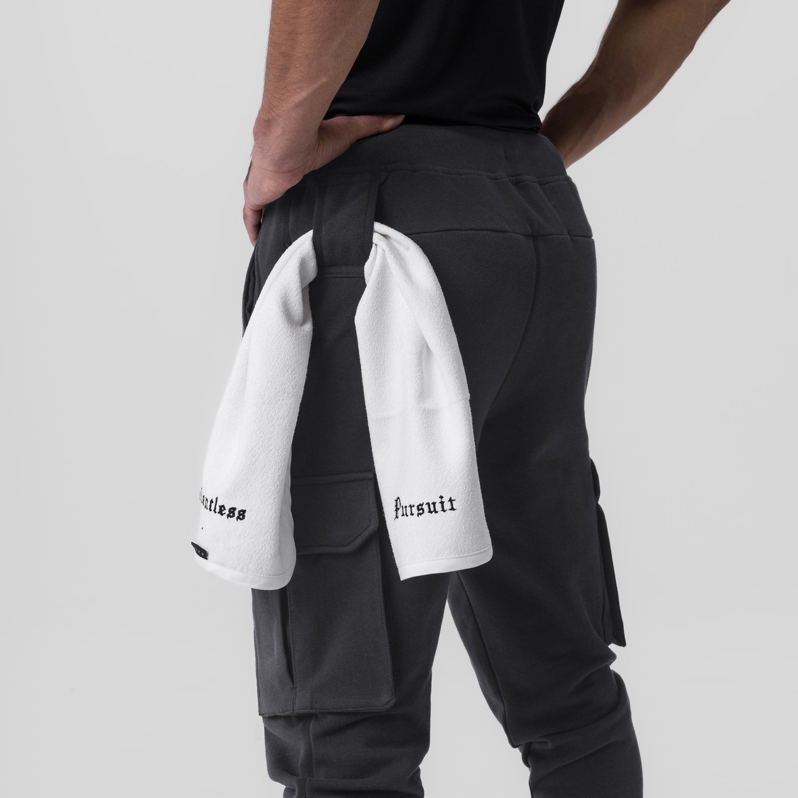 Tech-Terry Cargo High Rib Jogger in Dusk Black, worn by model with towel over shoulder, back view
