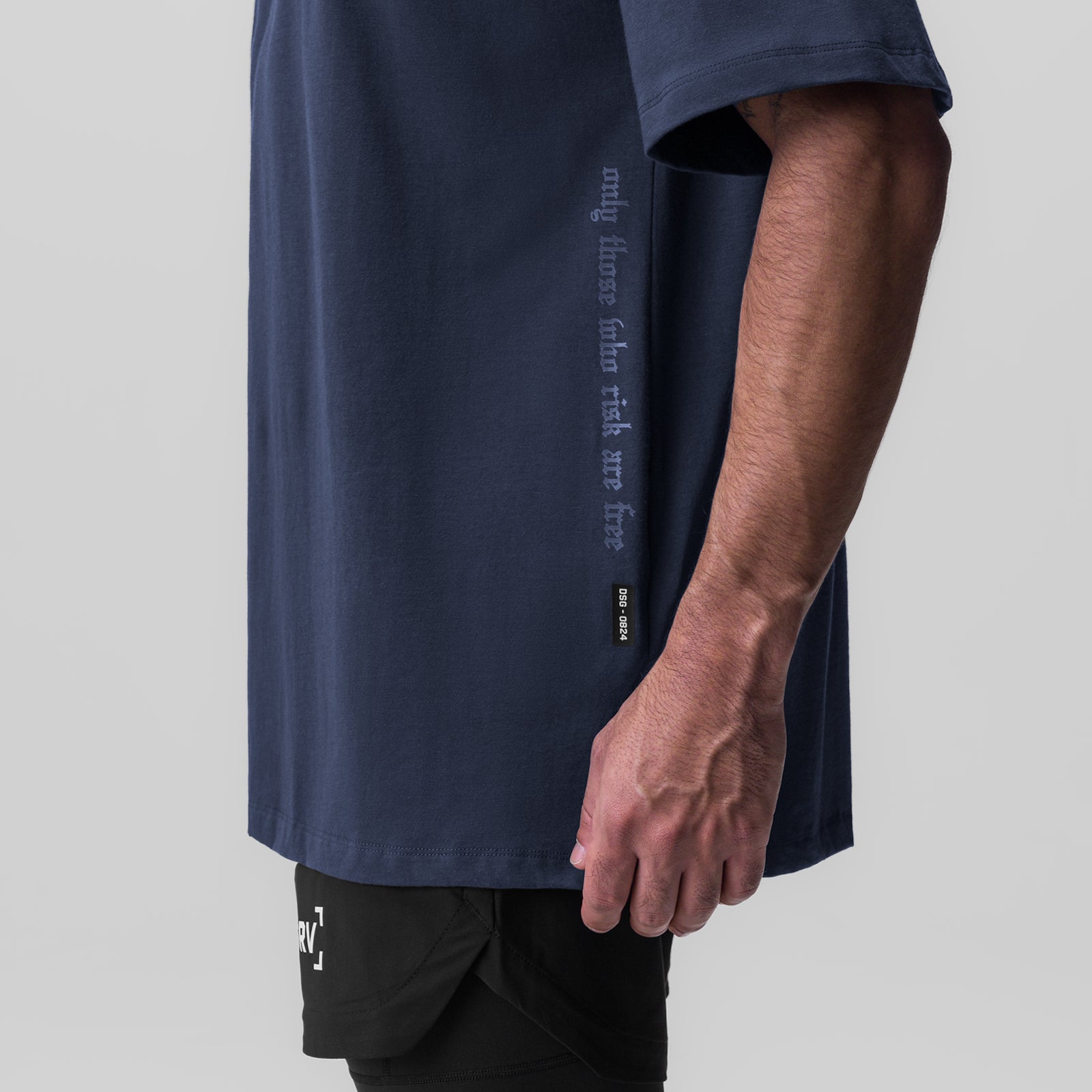 Navy oversized Supima tee worn by model, side view showing text details and fit