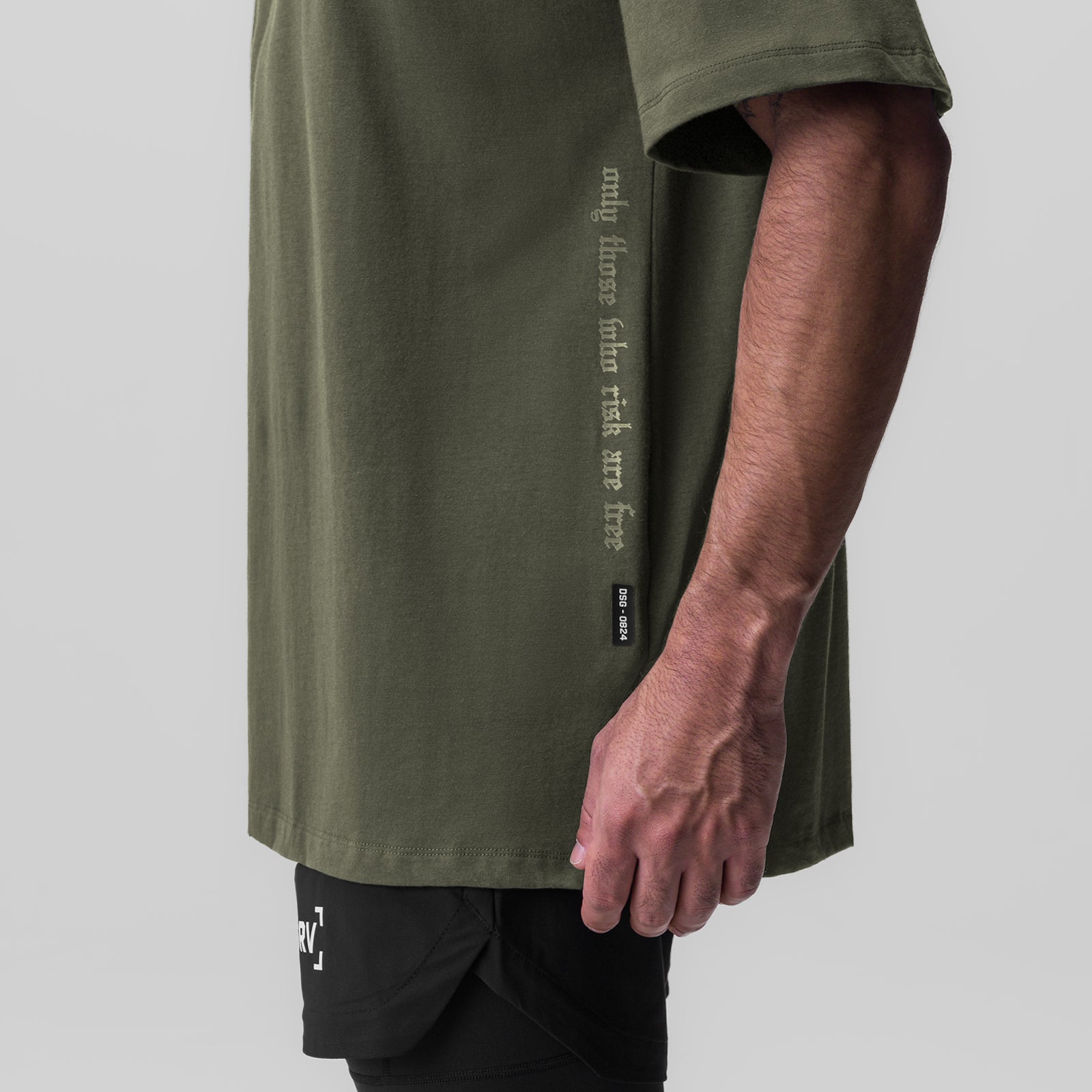 Olive Supima® Oversized Tee worn by model, side view showing text graphic