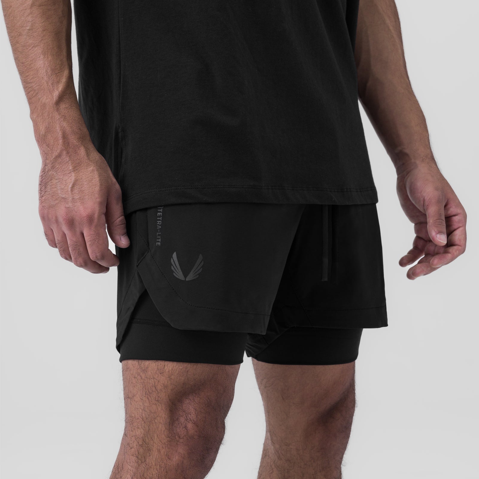 Tetra-Lite 5" Liner Shorts in black with Wings logo, worn by model, side view