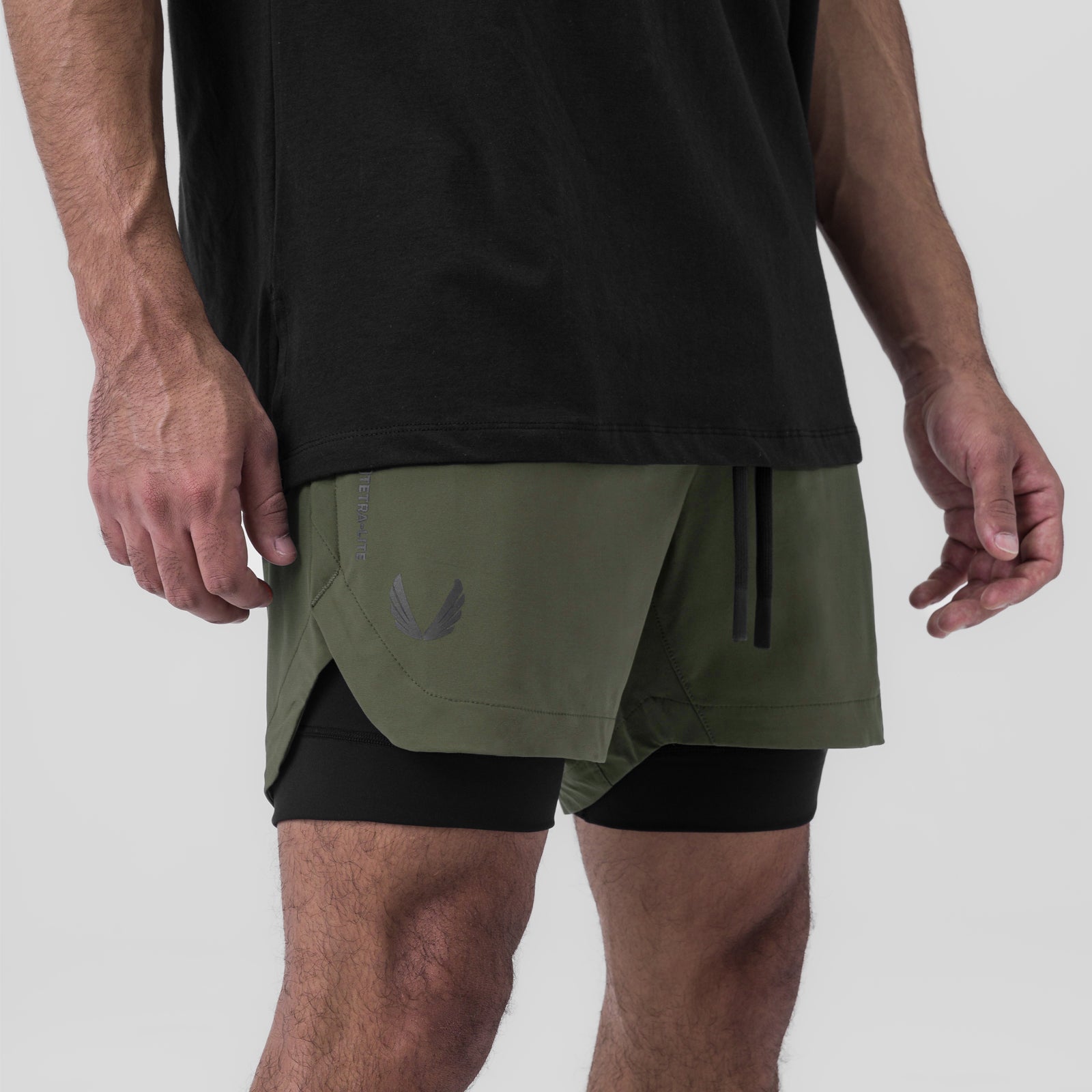 Tetra-Lite Liner Short in olive and black, modeled from side waist view