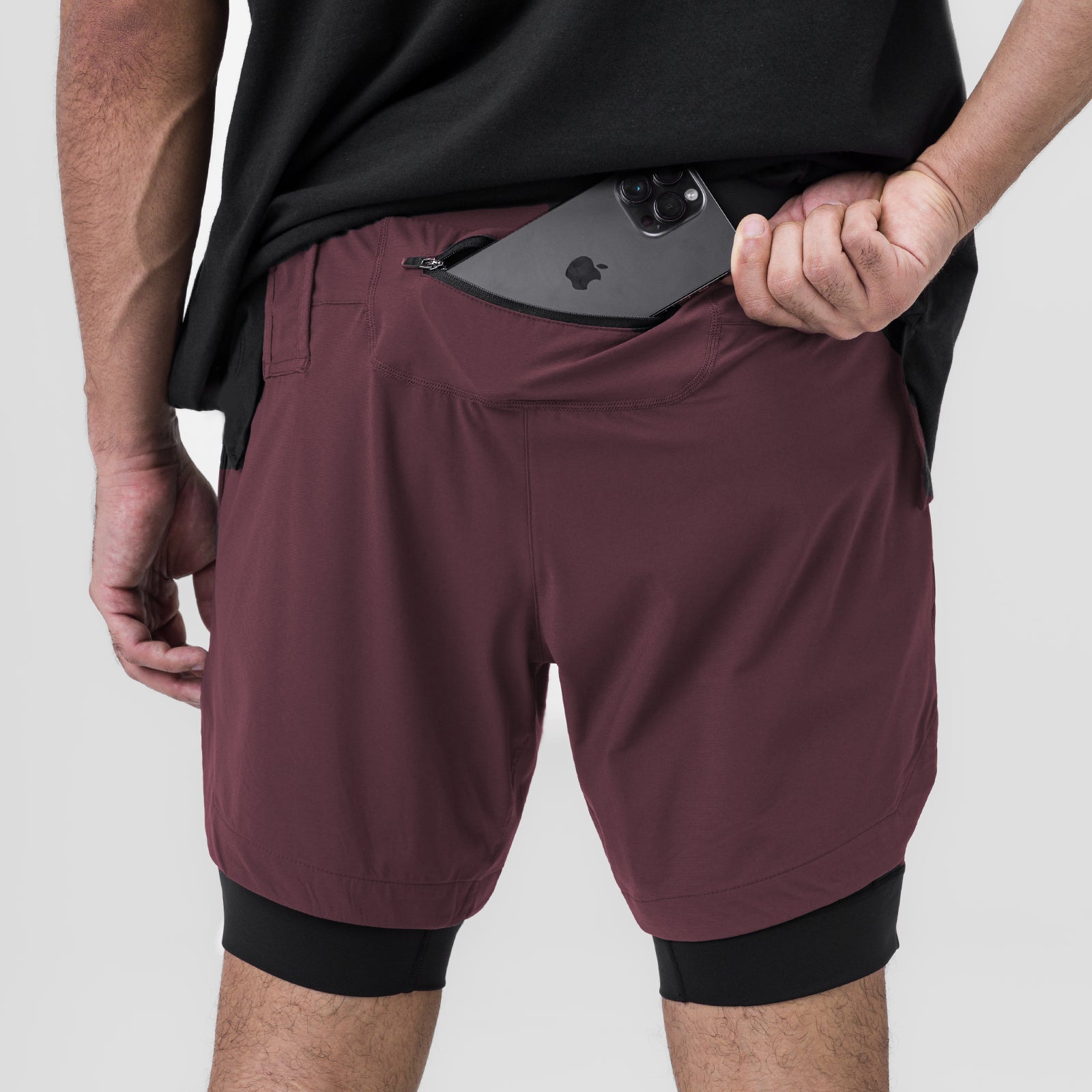 Tetra-Lite 7" Liner Short in Plum and Black worn by model, front view with phone in pocket