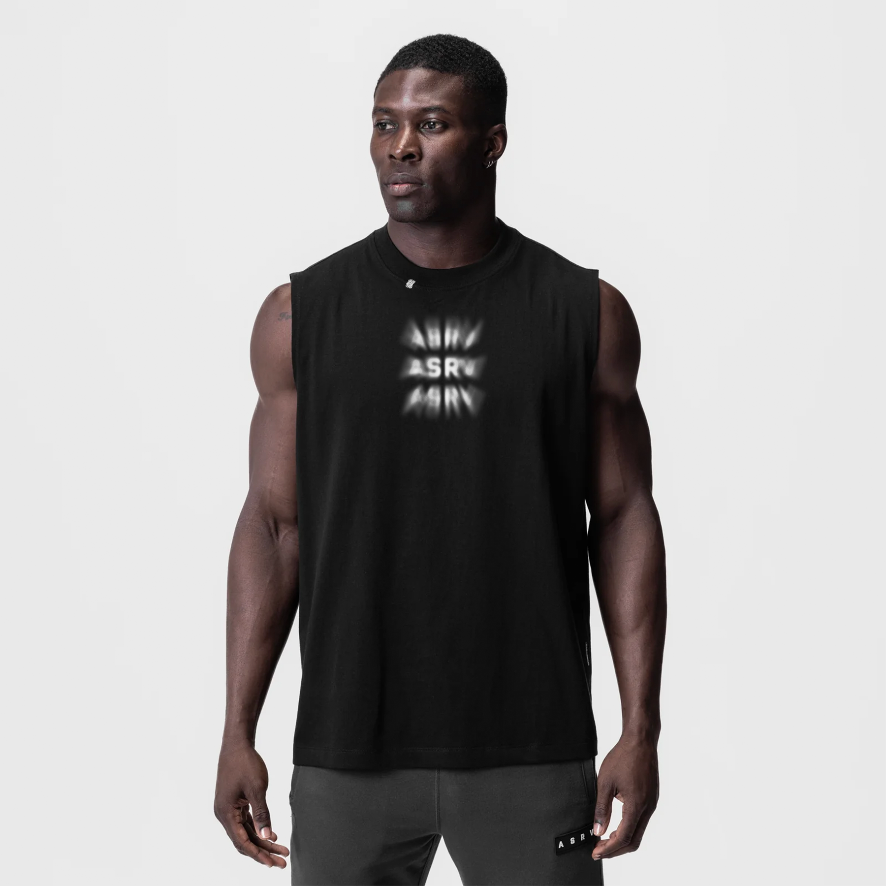 Black Tech Essential Relaxed Cutoff tank top worn by model, front view