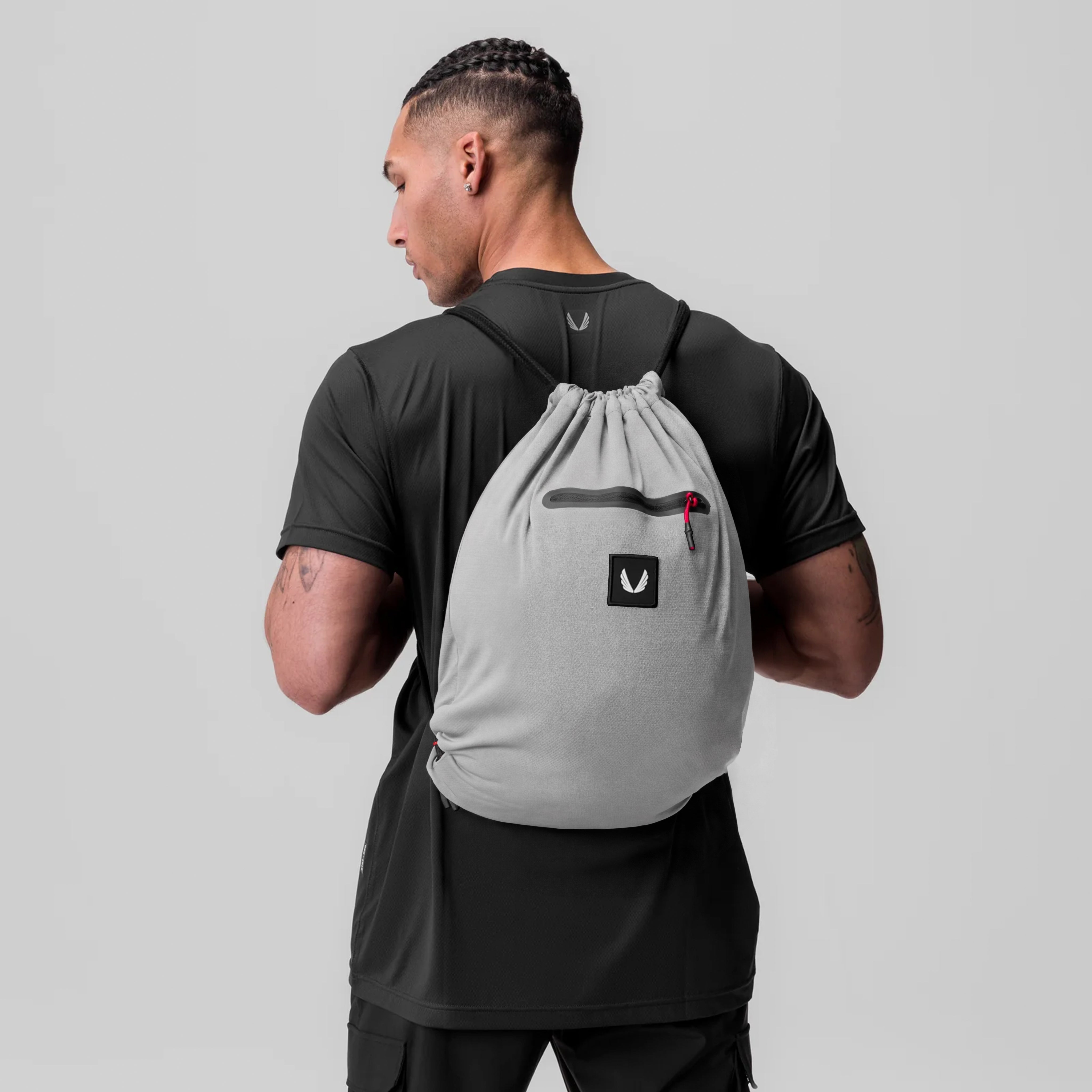 Antibacterial Mesh Drawstring Bag in slate grey, worn as backpack by model in black tee, back view