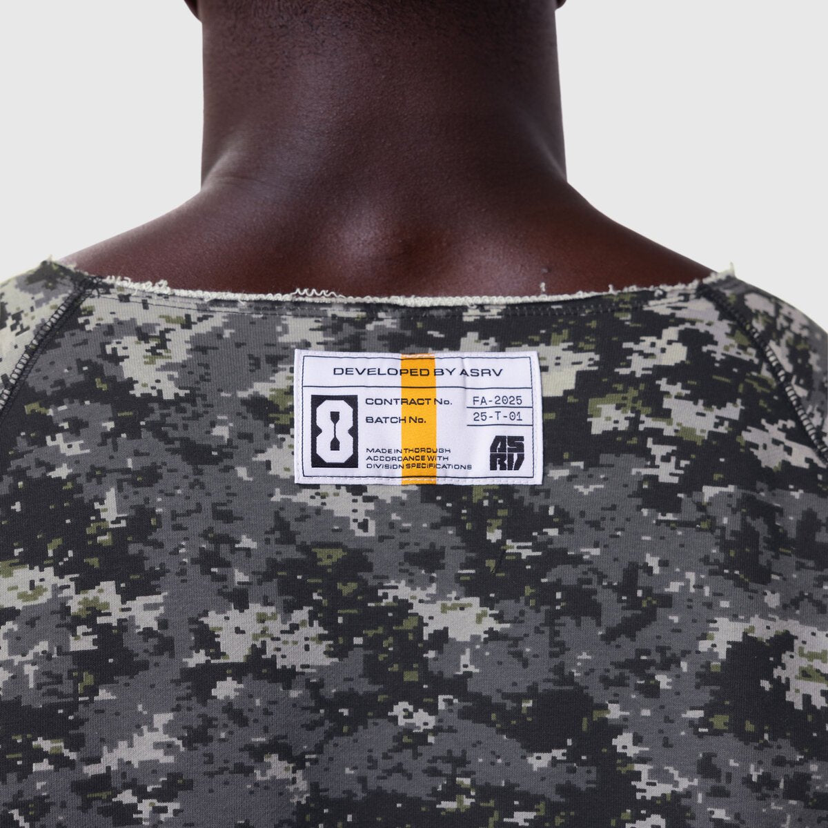 Vintage Raw Hem Pump Cover in pixel camo worn by model, back view showing label