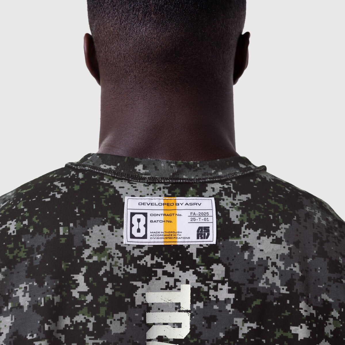 Tech Essential Cap Shoulder Cutoff in pixel camo worn by model, back view showing label