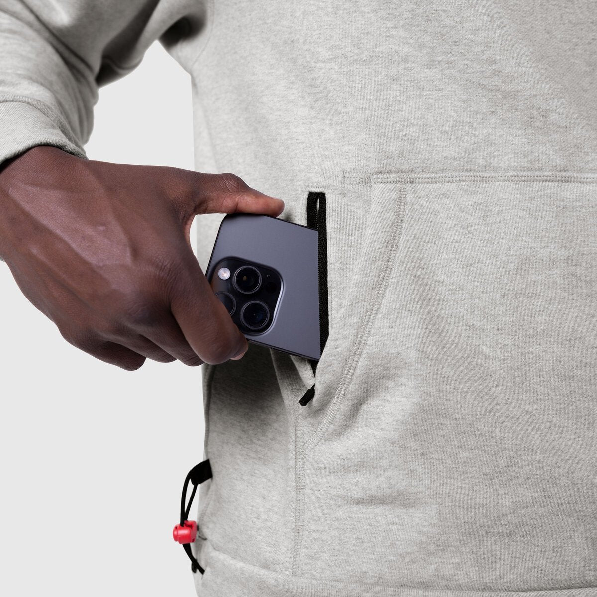 Tech-Terry Training Hoodie in heather grey, model holding phone in pocket