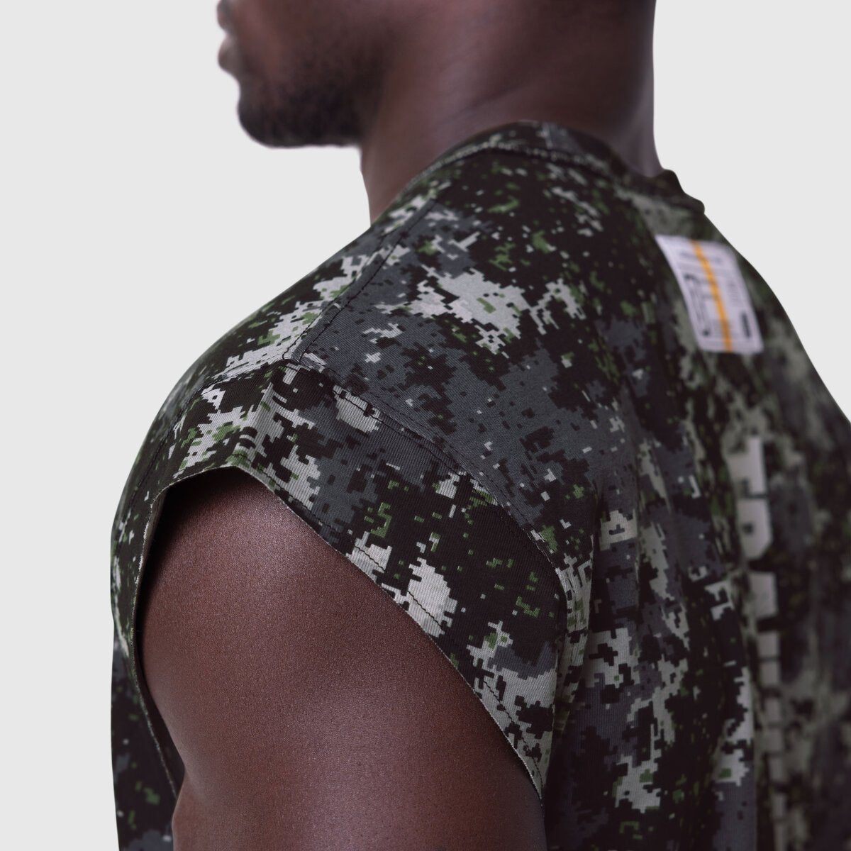 Tech Essential Cap Shoulder Cutoff in Pixel Camo worn by model, side view
