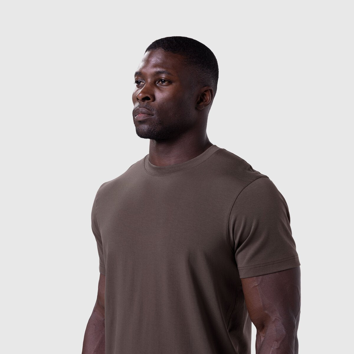 Supima® Essential Tee in Dark Earth, worn by model in profile pose