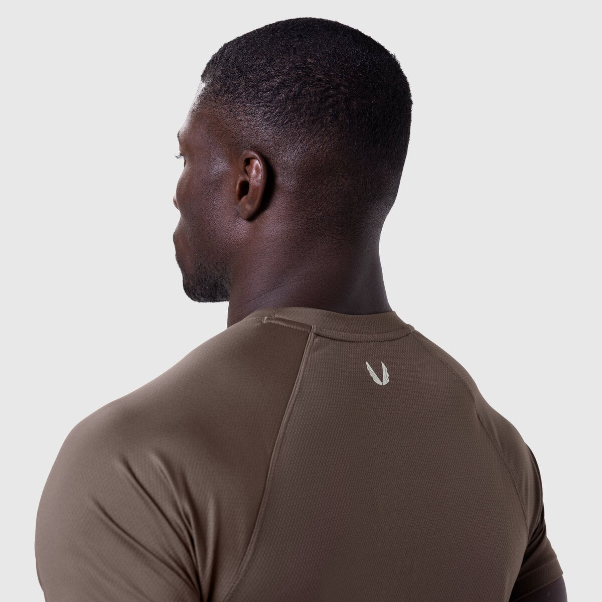 AeroSilver Established Tee in Dark Earth worn by model, back view