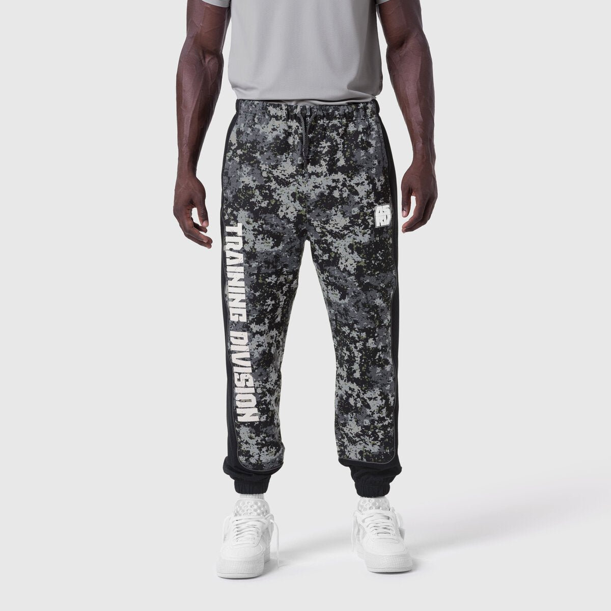 Tech-Terry Mesh Panel Sweats in pixel camo black, worn by model with white sneakers, front view