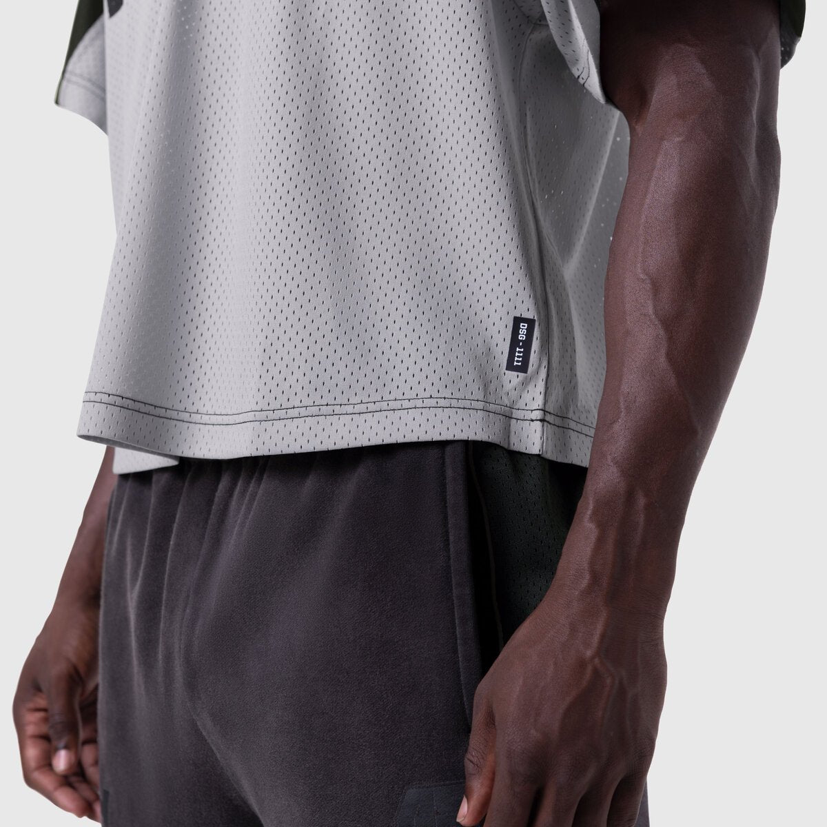 Ion-Mesh Crop Jersey in slate grey worn by model, side view detail