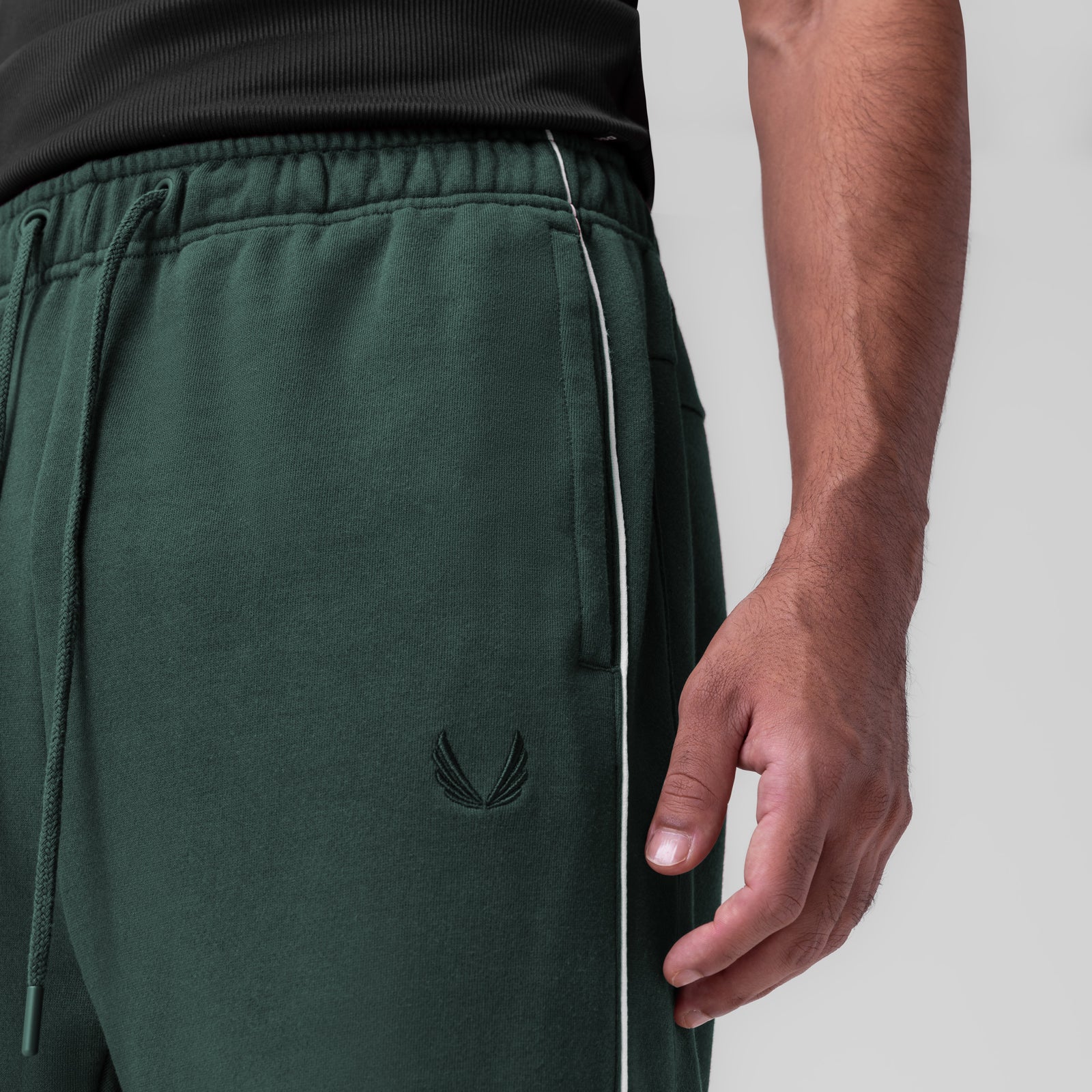 Herringbone Terry Snap Button Sweats in forest green, worn by model showing side detail and pocket