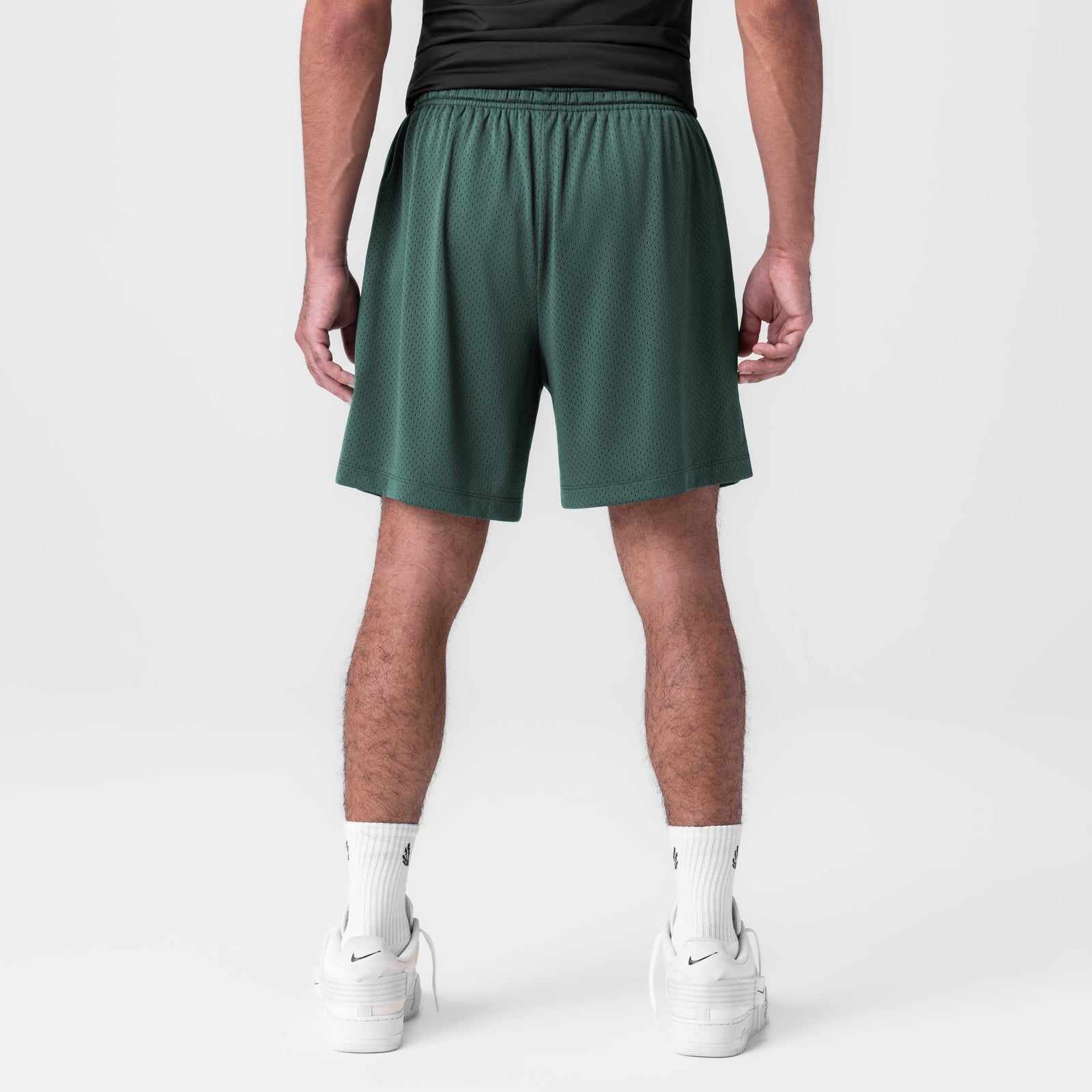 Reversible 2-in-1 shorts in forest green worn by model, back view