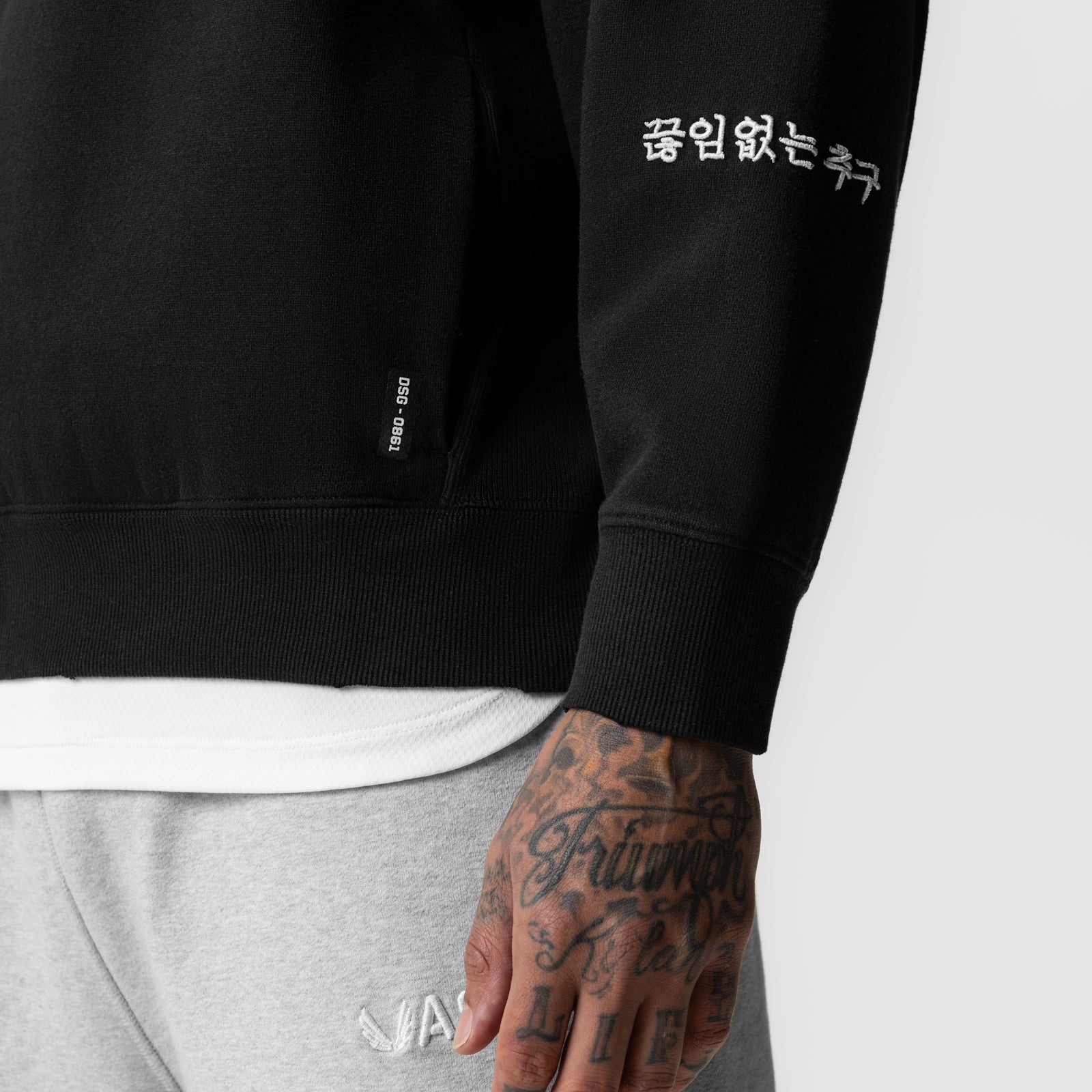 Black Tech Essential Distressed Crewneck worn by model, close-up of torso and arm detail