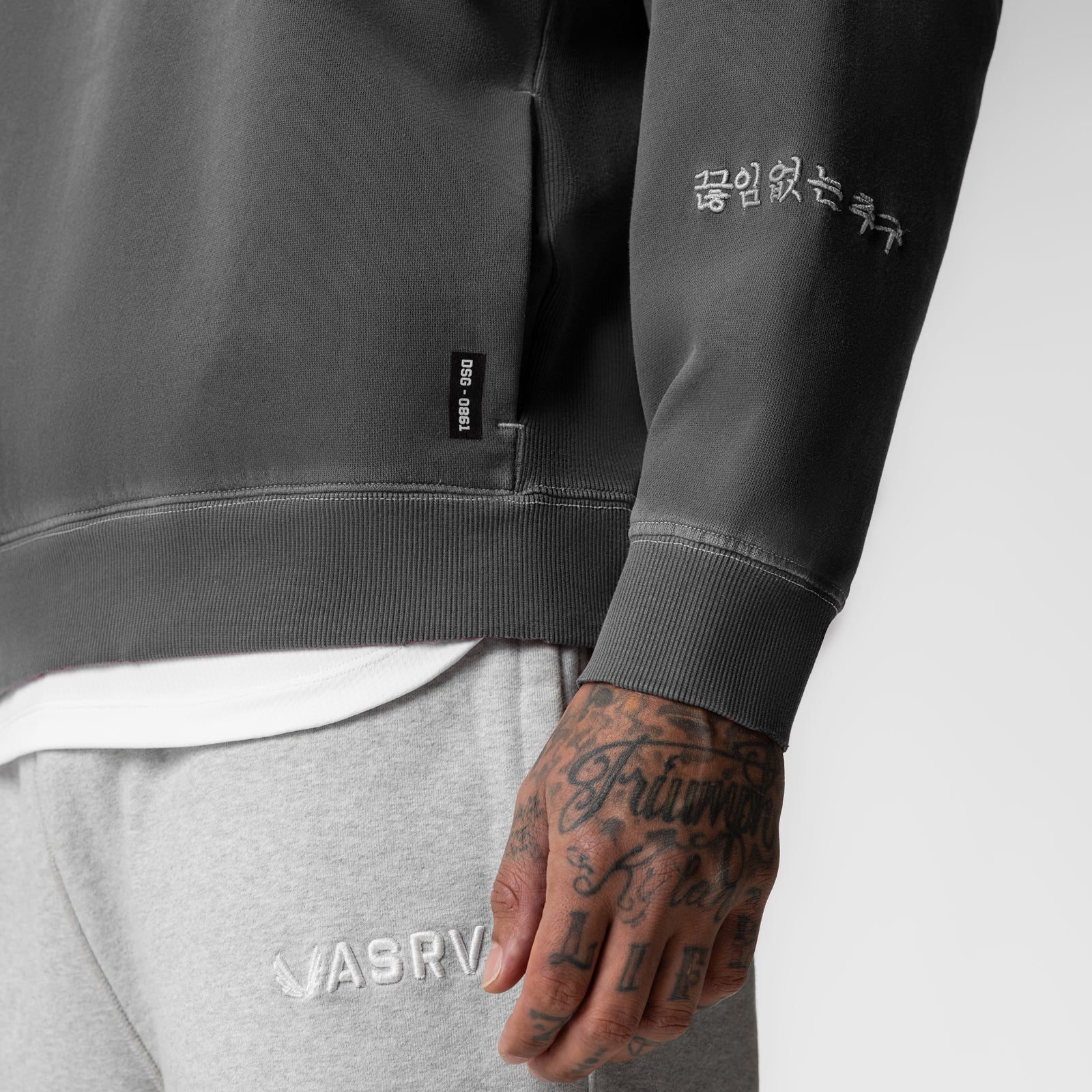 Tech Essential Distressed Crewneck in faded grey worn by model, close-up detail shot