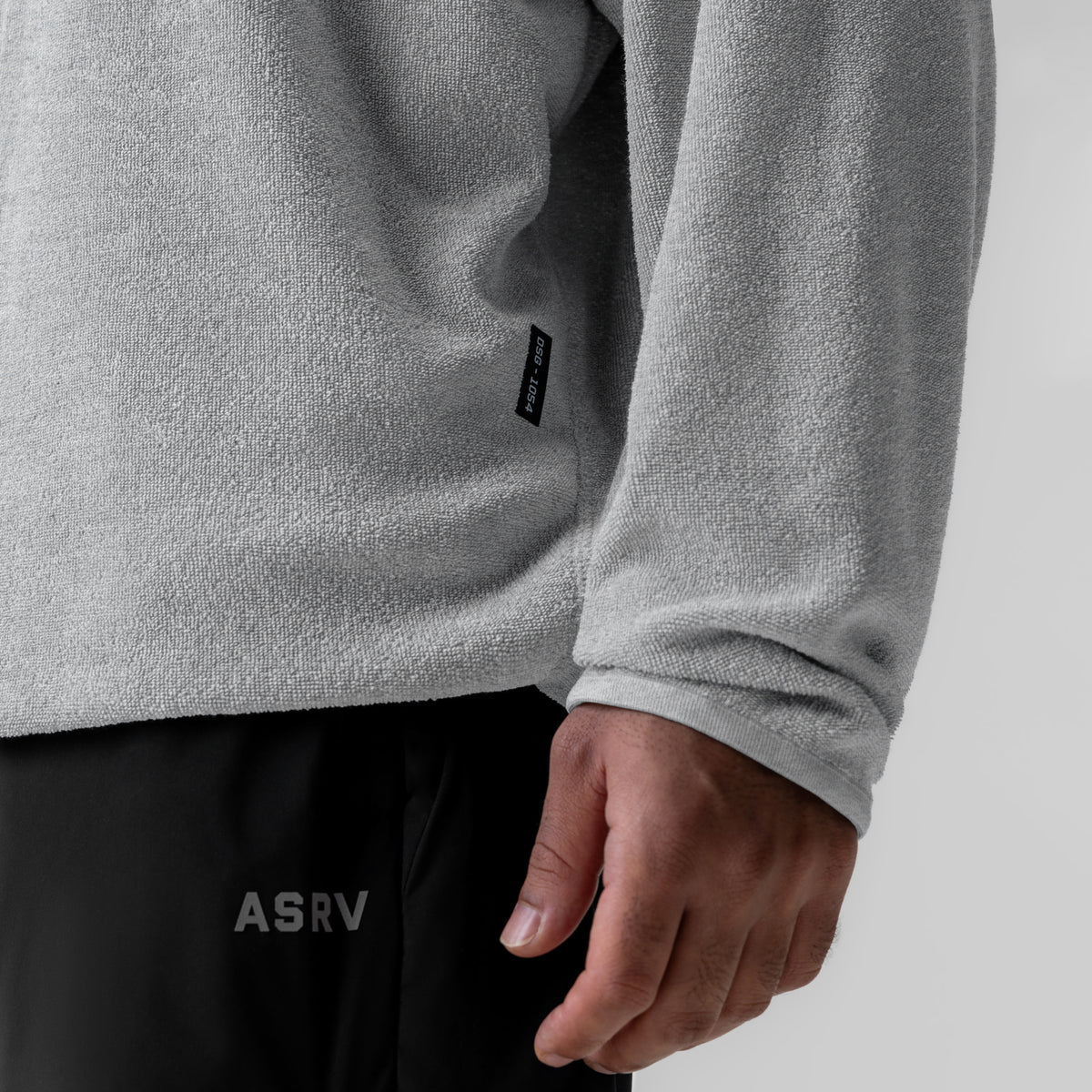 Towel Terry Reversible Hoodie in heather grey worn by model, detail shot of sleeve and torso