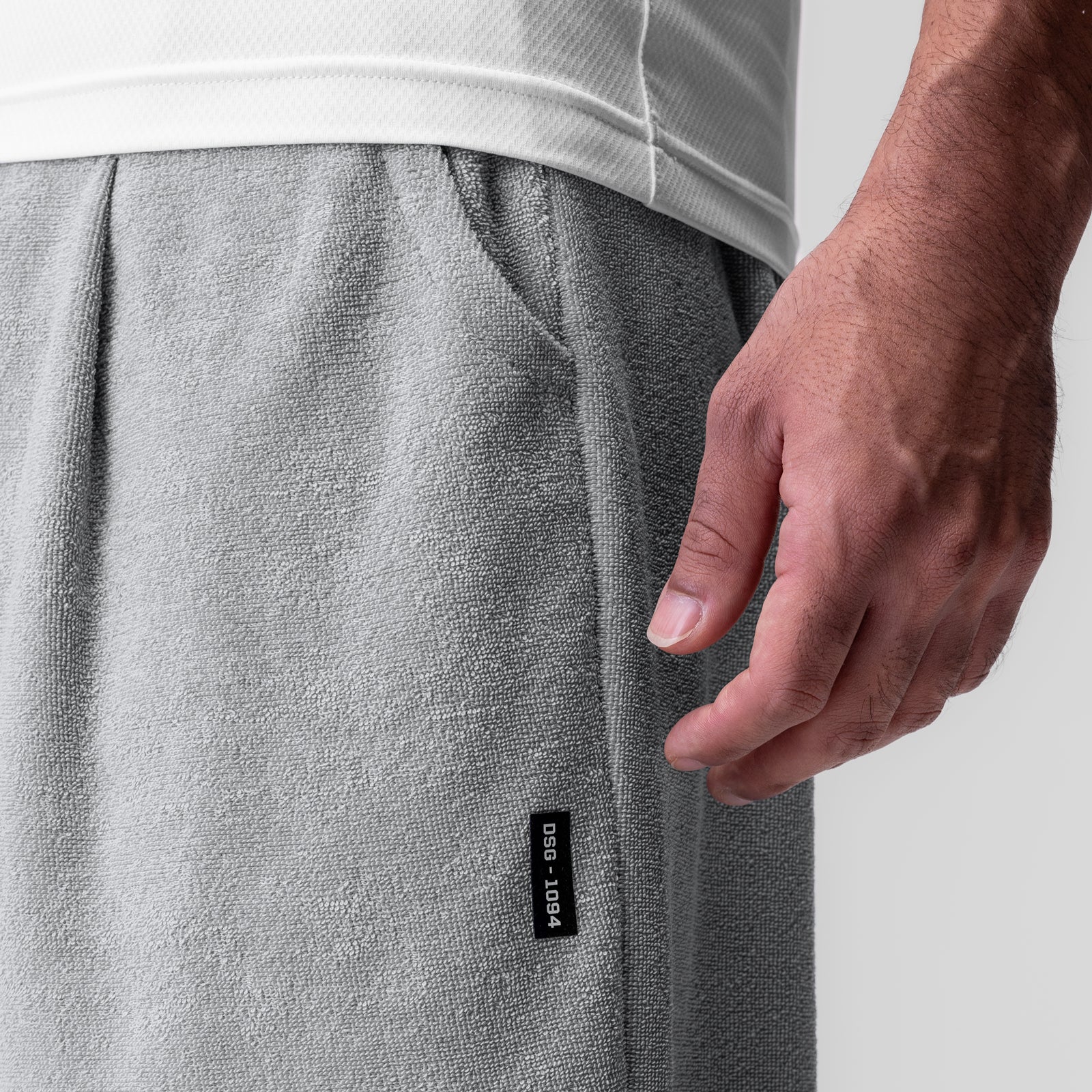 Towel Terry Relaxed Short in heather grey, worn by model with hand in pocket detail
