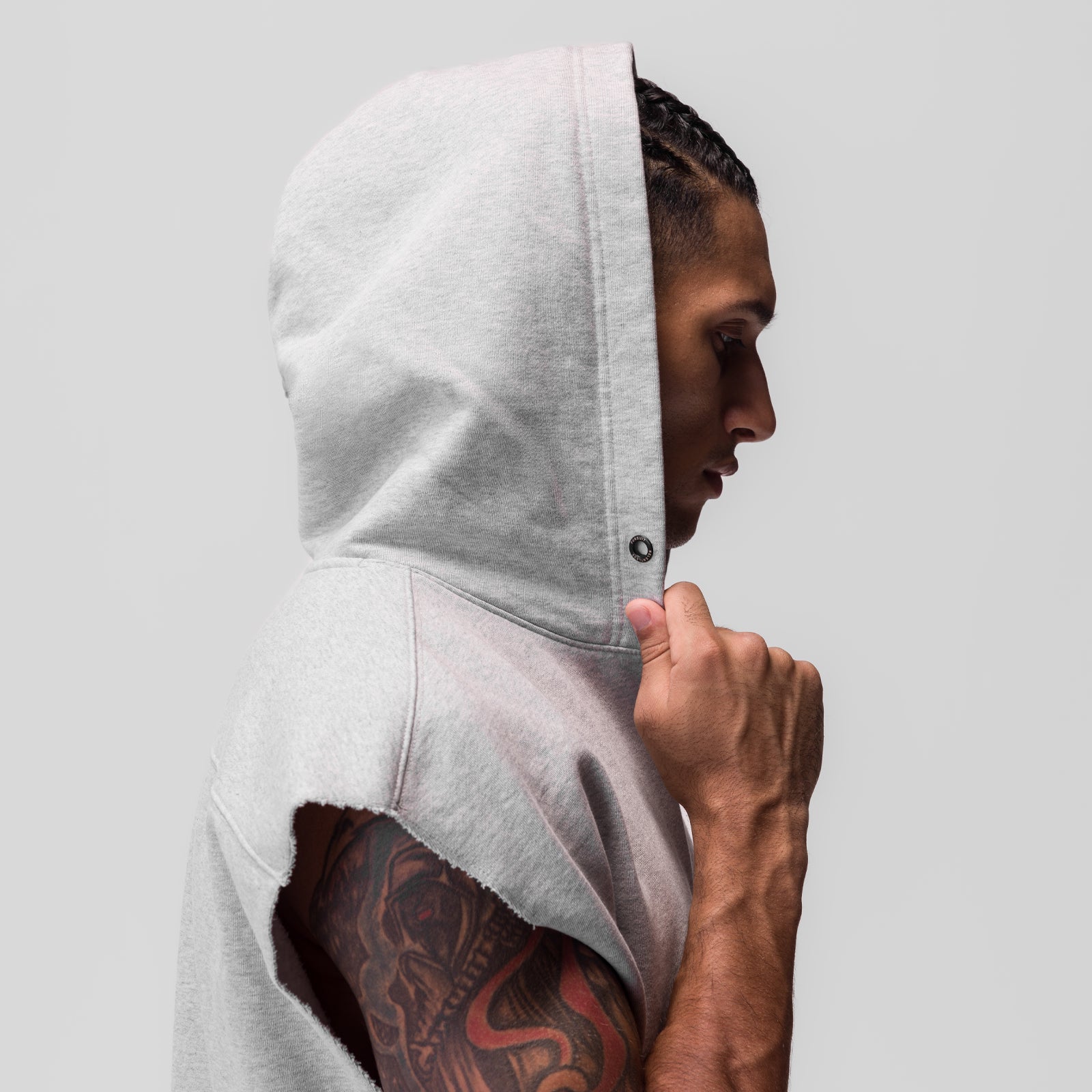 Tech Essential Raw Hem Cutoff Hoodie in Heather Grey, worn by model showing side profile and hood detail