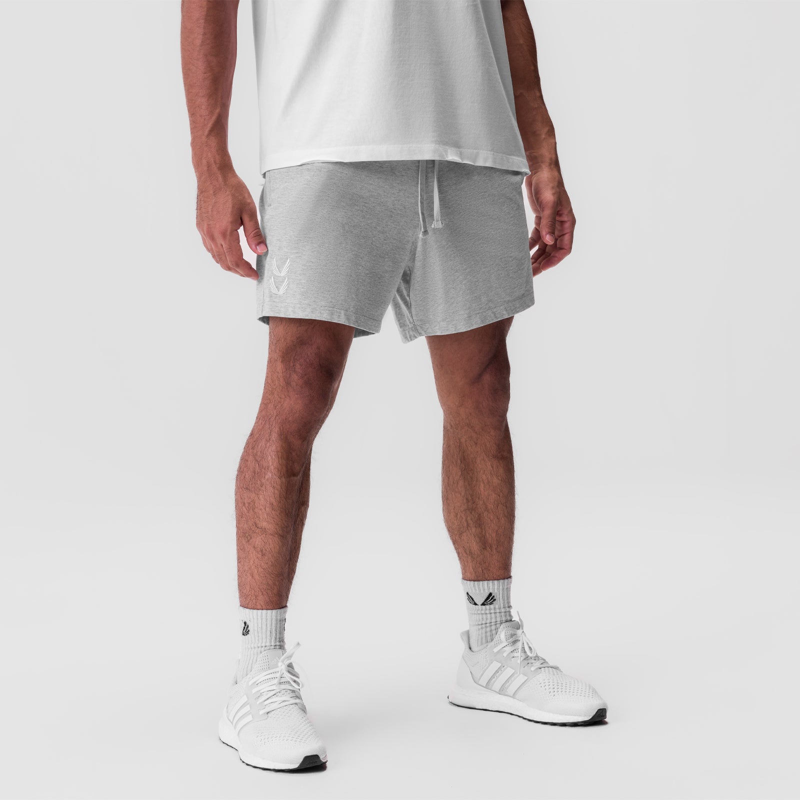 Tech Essential Sweat Short in Heather Grey, modeled with white tee and sneakers