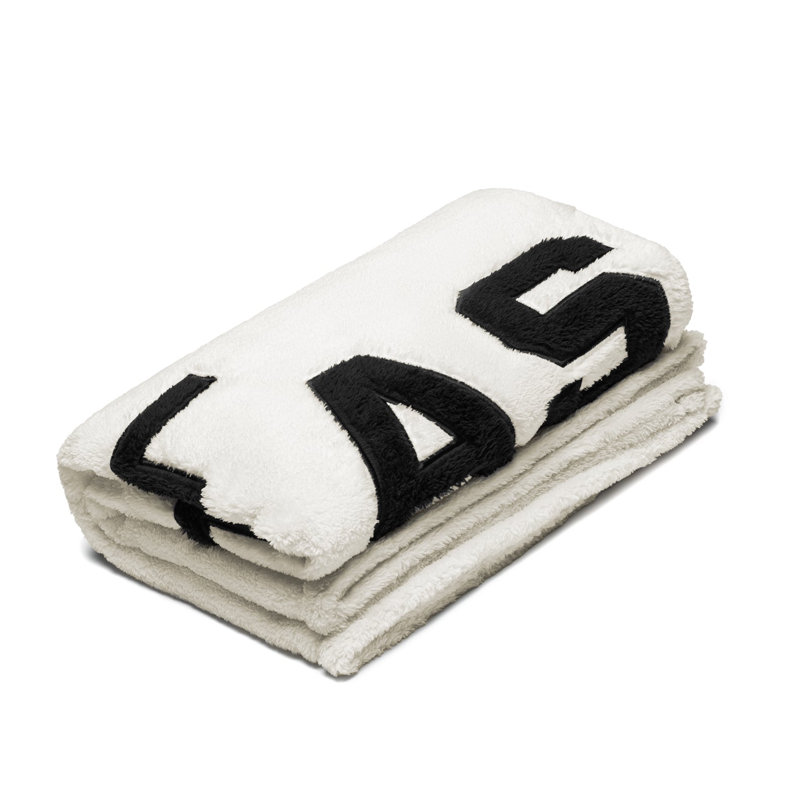 flatlay Sherpa Recovery Blanket in ivory cream and black, rolled and stacked view