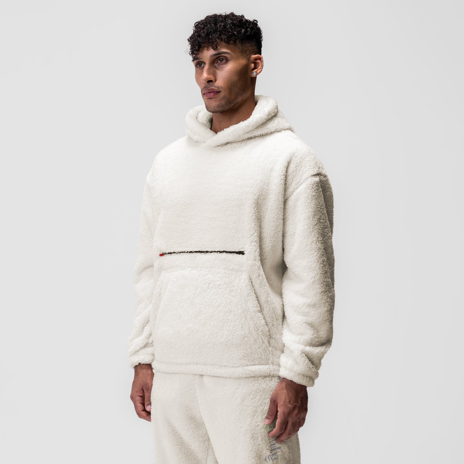 Sherpa Recovery Hoodie in ivory cream with black stripe, worn by model, front view