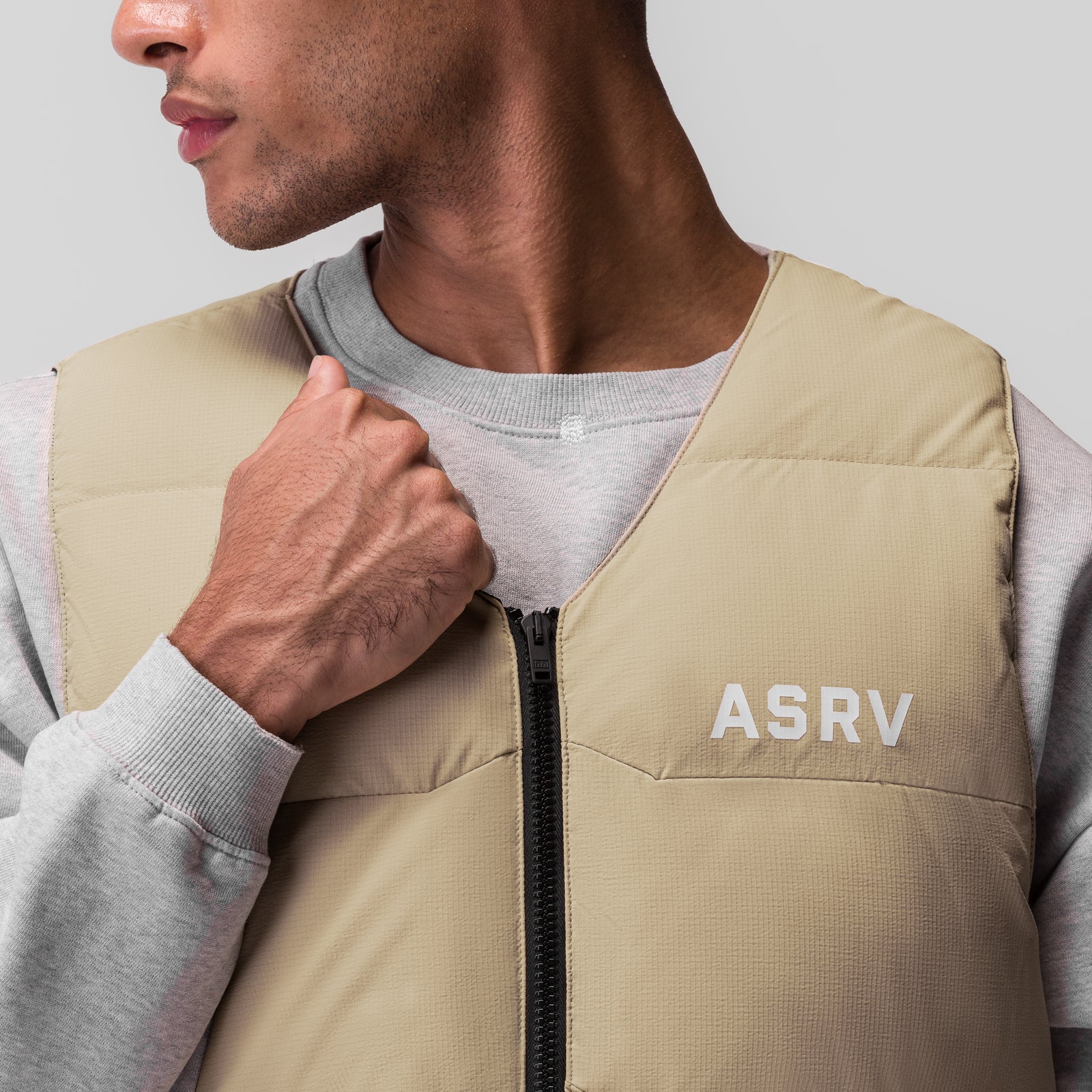 Ripstop Insulated Puffer Gilet in khaki, worn by model, front view with zip detail