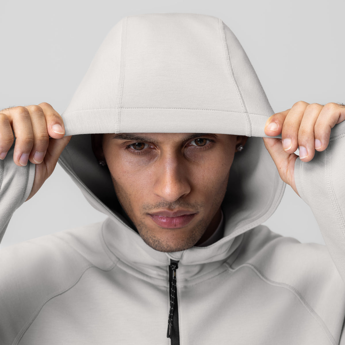 Dri-Core™ Zip Hoodie in light grey worn by model with hood pulled up, front view