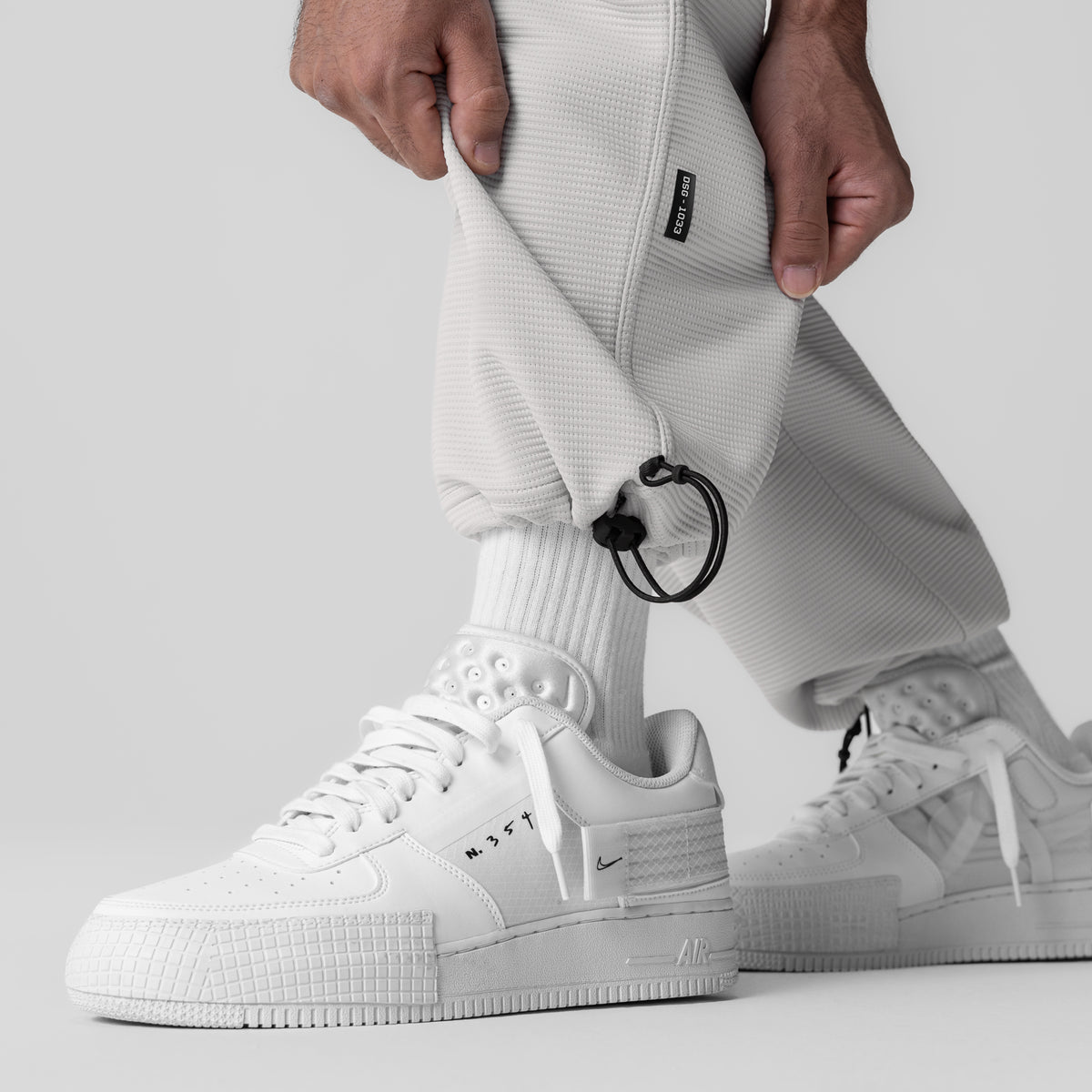 Deltapeak® Cargo Cinch Jogger in light grey worn with white sneakers, side view