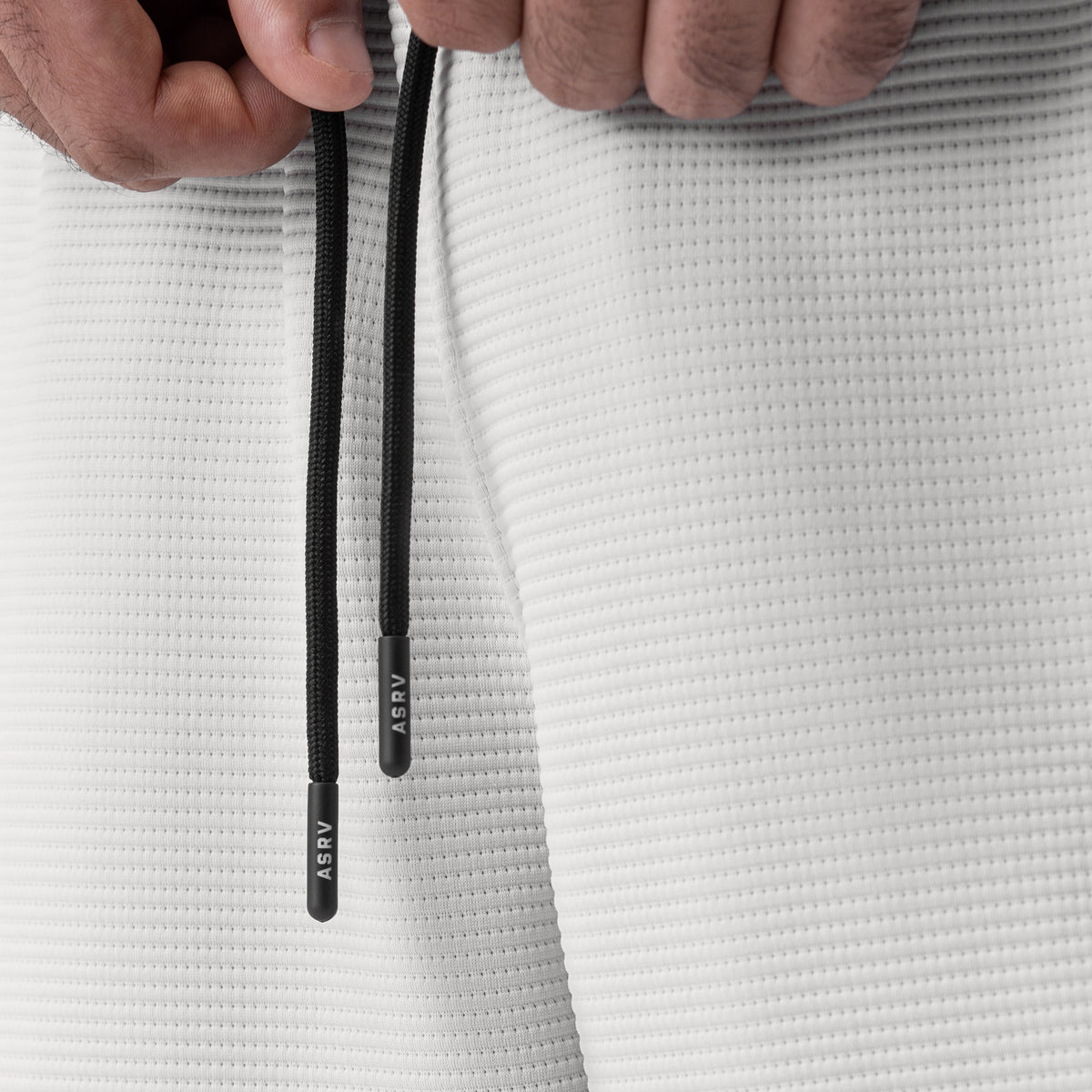 Deltapeak® Cargo Cinch Jogger in light grey, drawstring detail closeup held by model