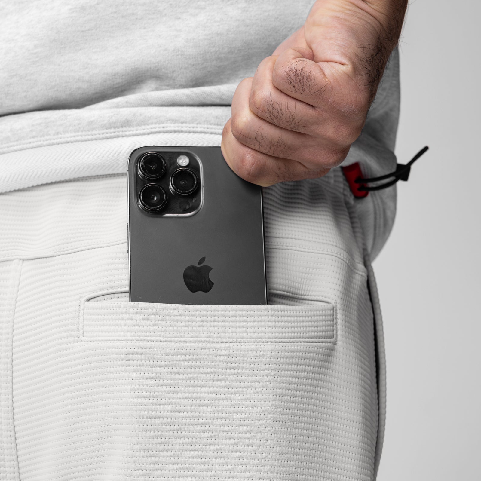 Light grey Deltapeak® straight leg sweats worn by model, phone in pocket detail